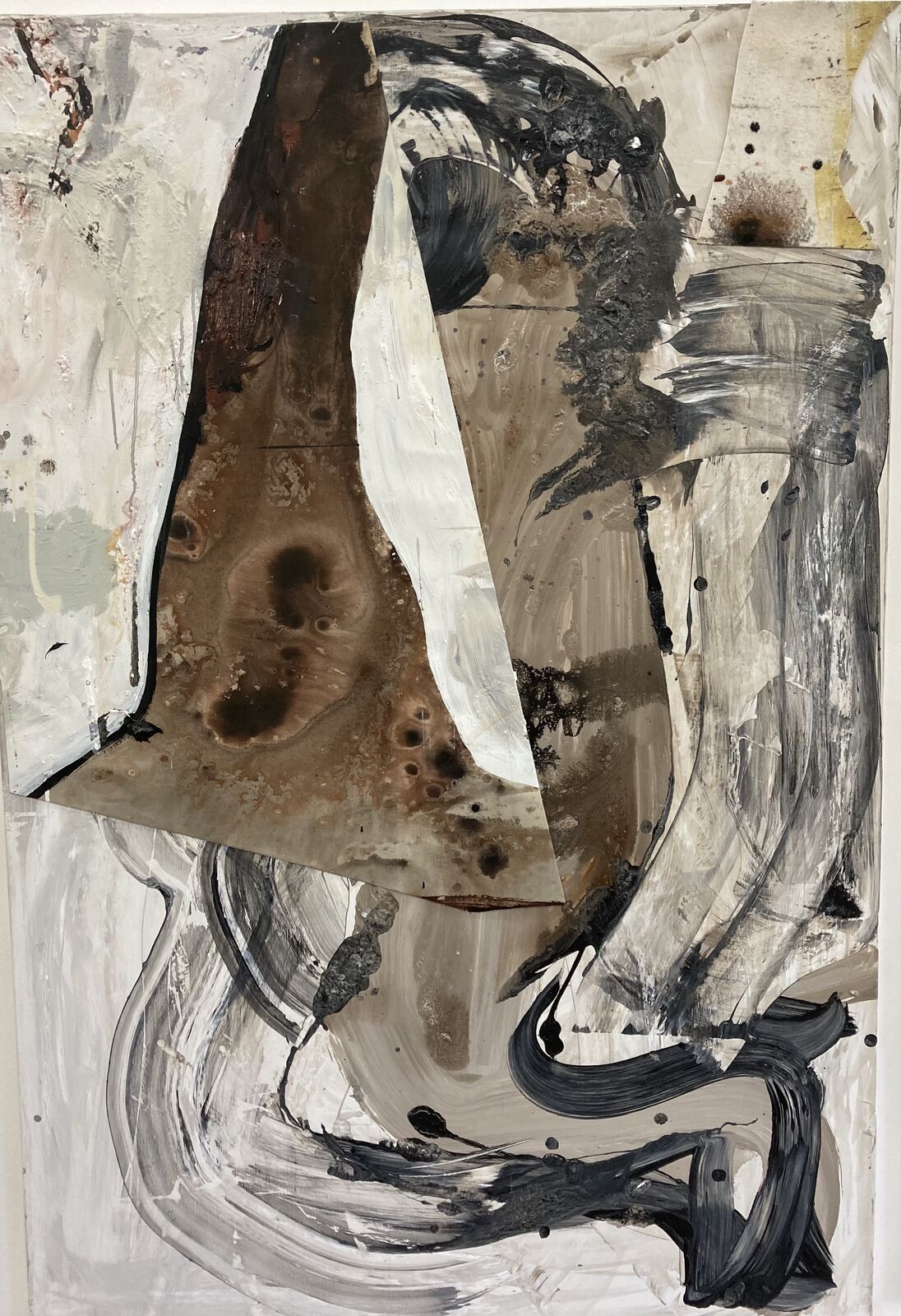 A painting with black and white paint on a piece of paper.