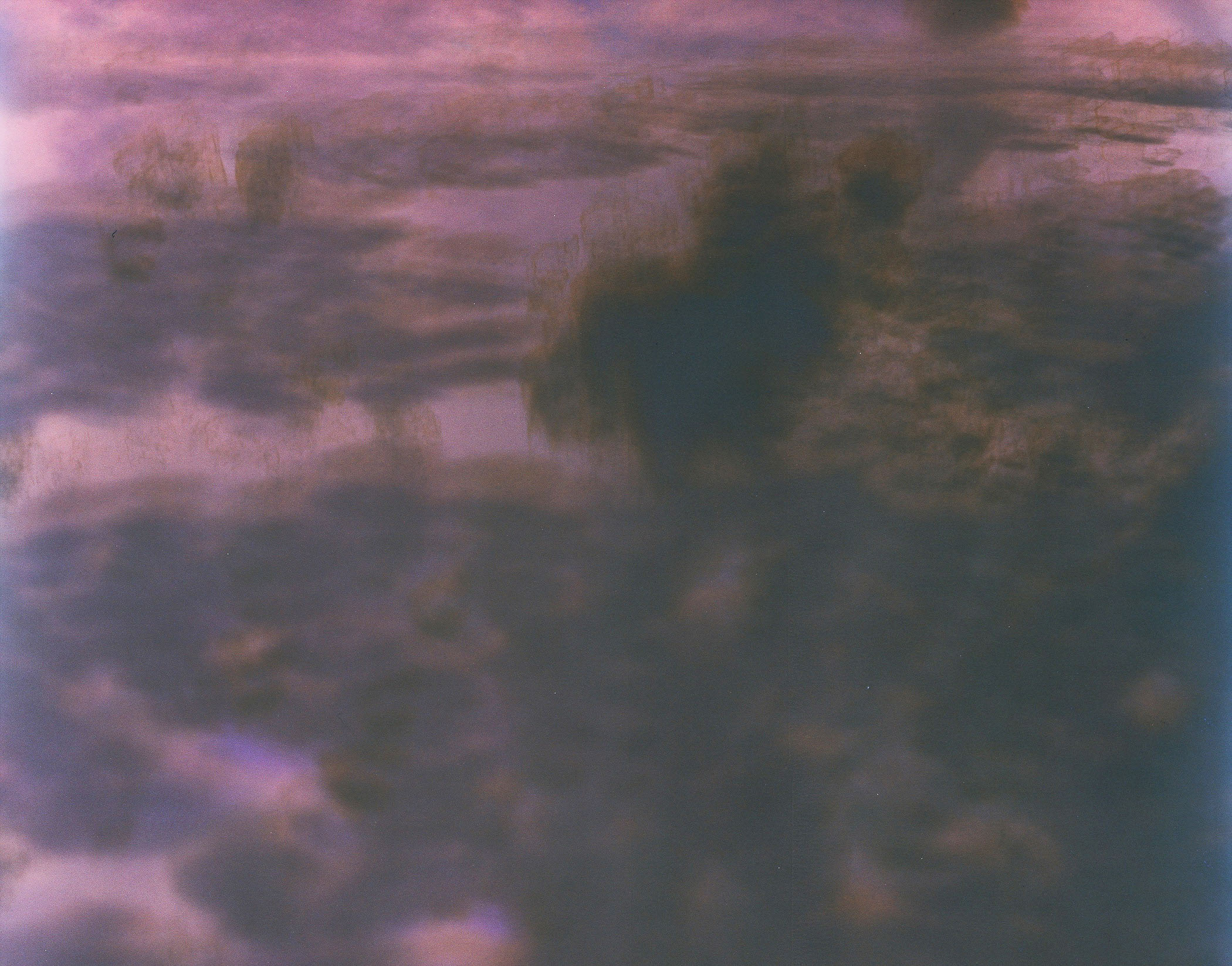 A picture of a cloudy sky over a body of water.