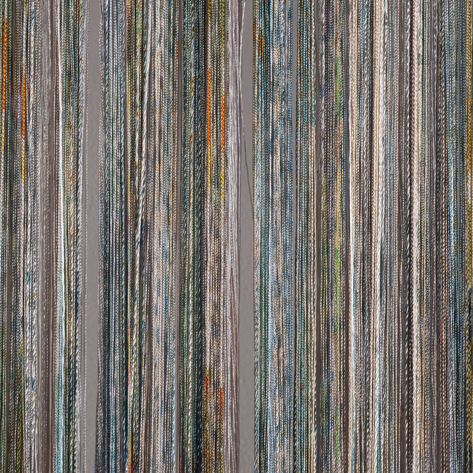 A minimalist textile artwork featuring a dense curtain of vertical threads in muted blues and creams.