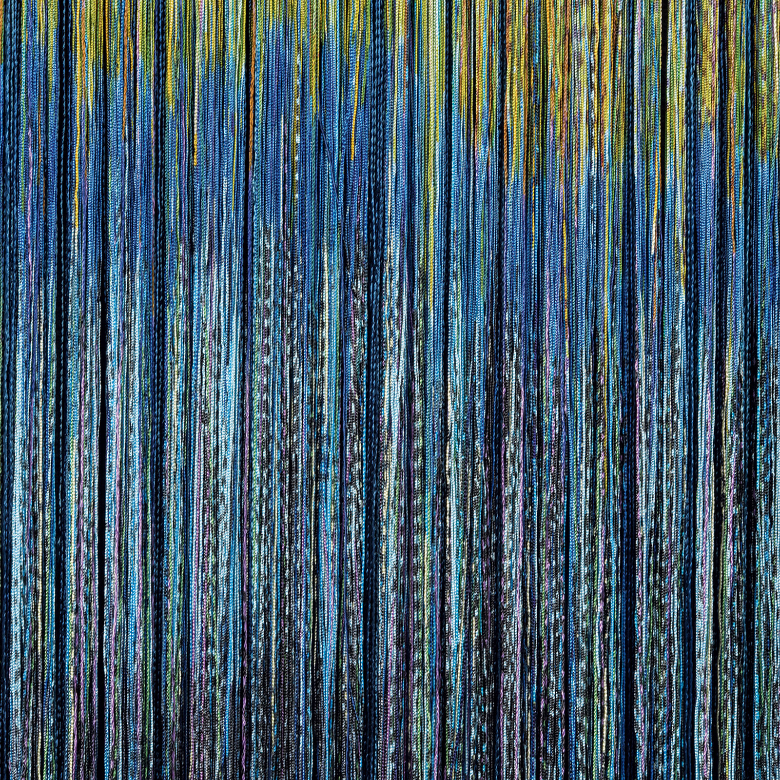 A large blue and yellow painting hanging on a wall.
