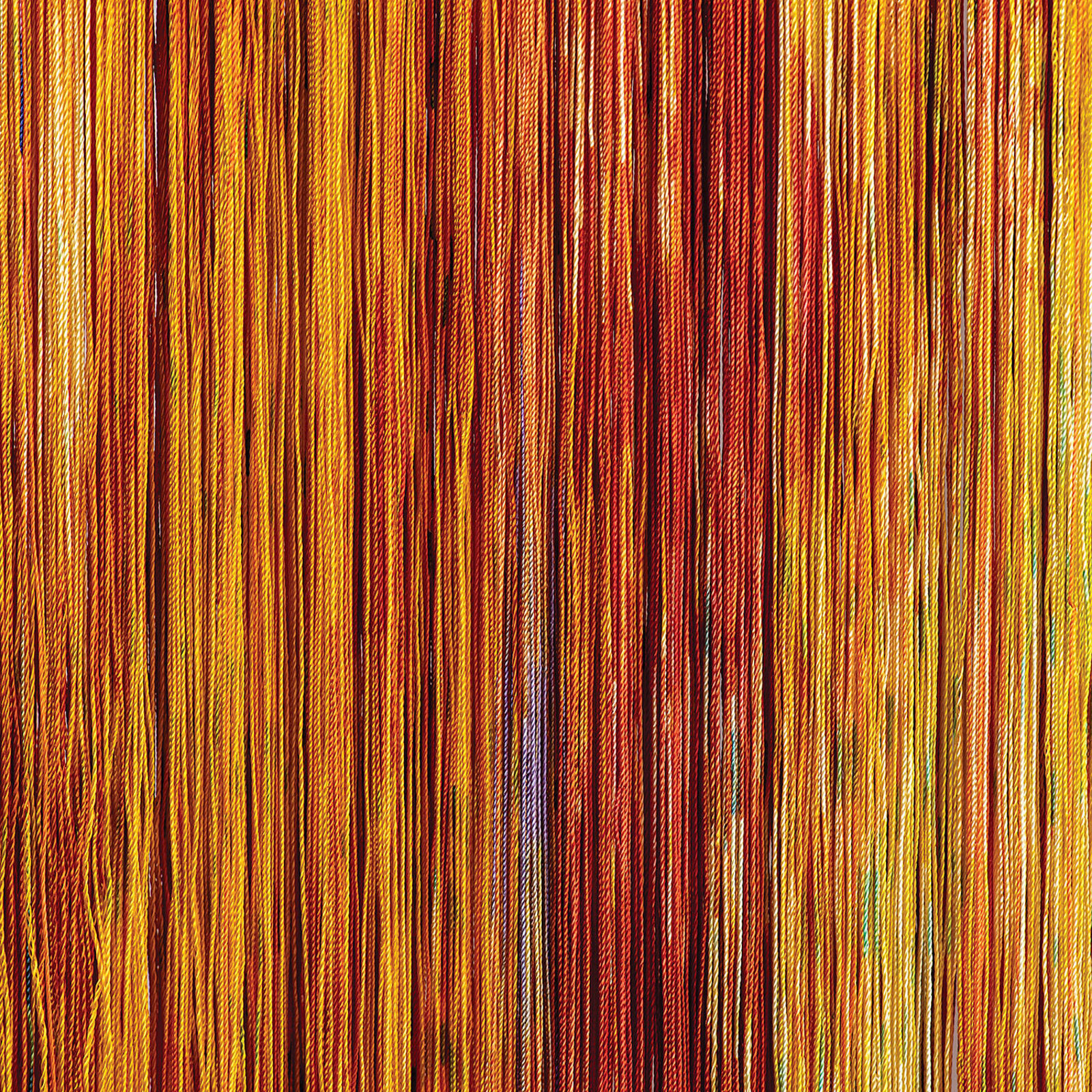 A wall hanging on a wall next to a window.