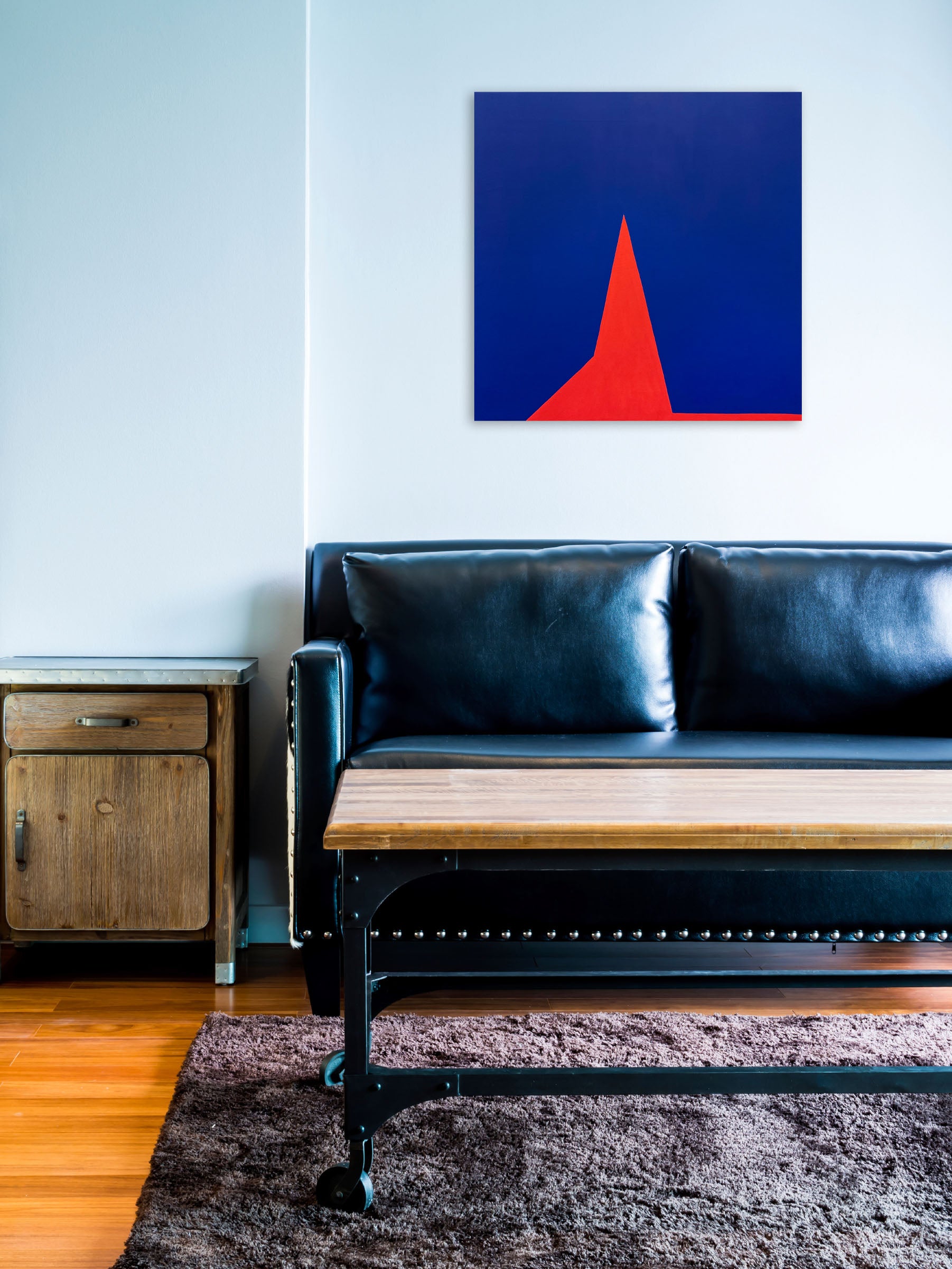 A red triangle on a blue background. 