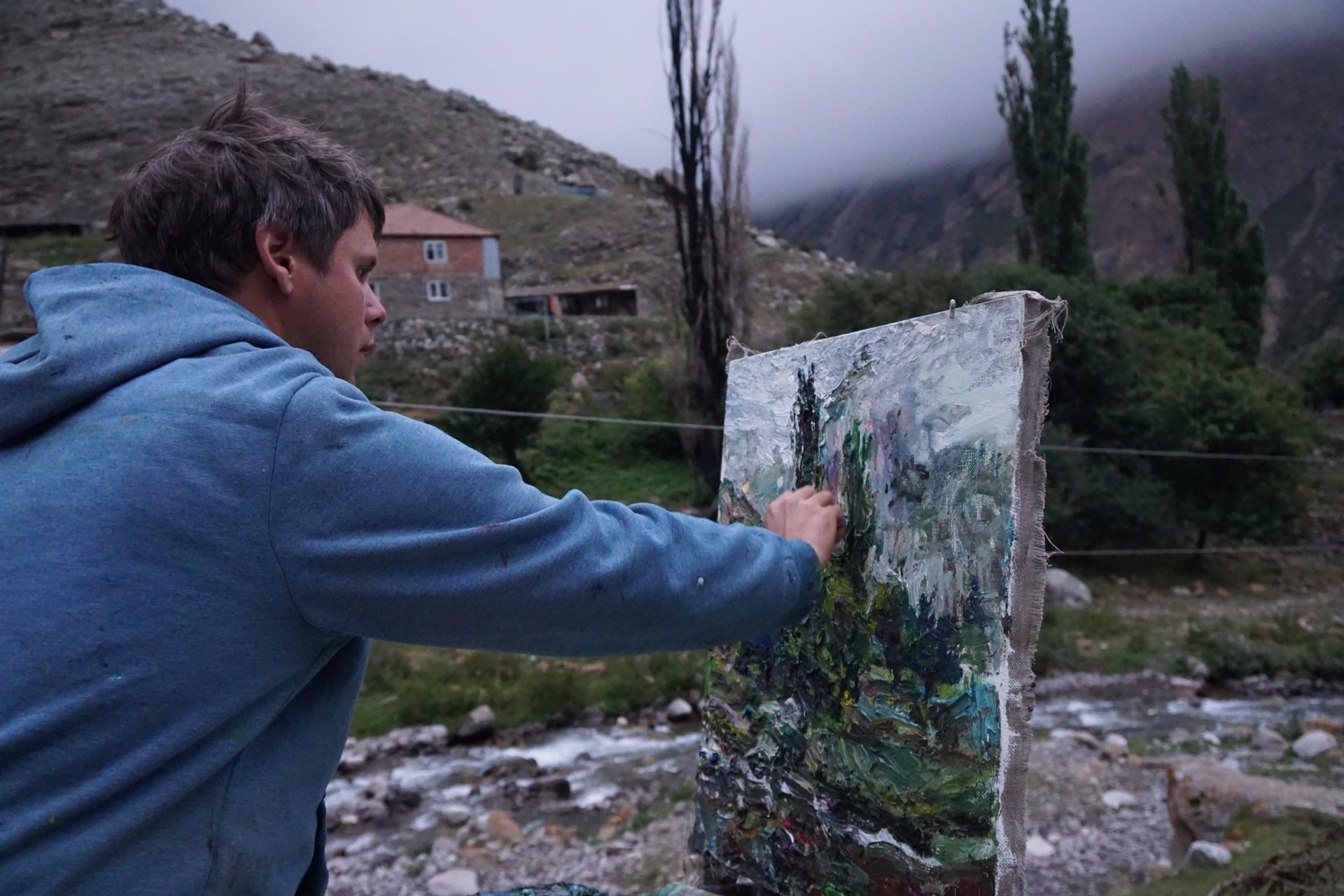 A painting of a landscape with trees in the background.