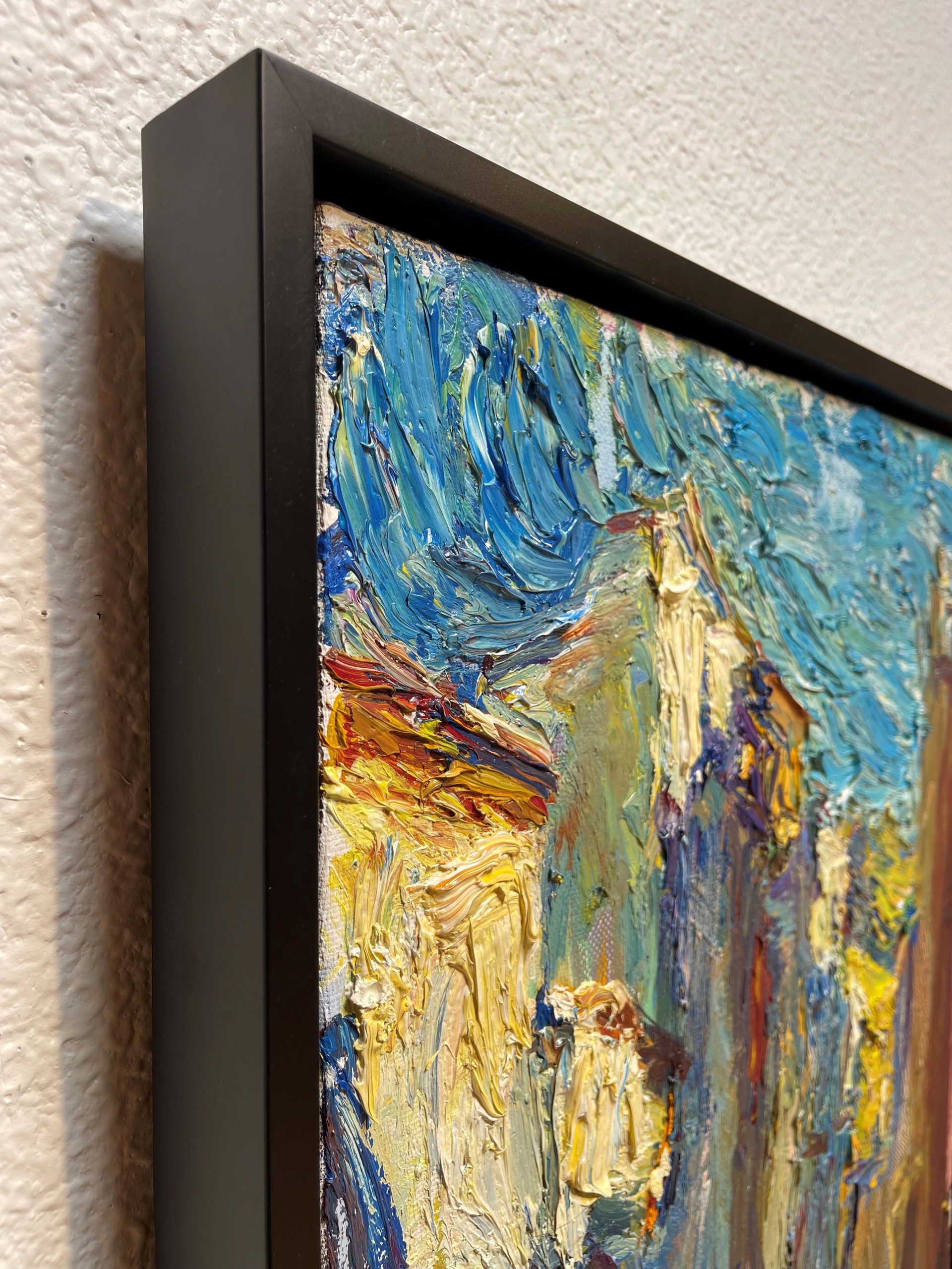 A painting of a city street with buildings in the background.