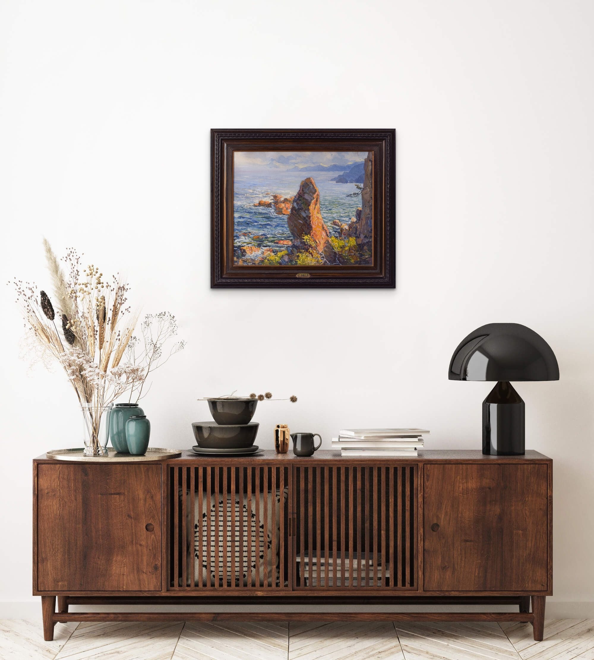 A painting of a rocky shoreline with a body of water.