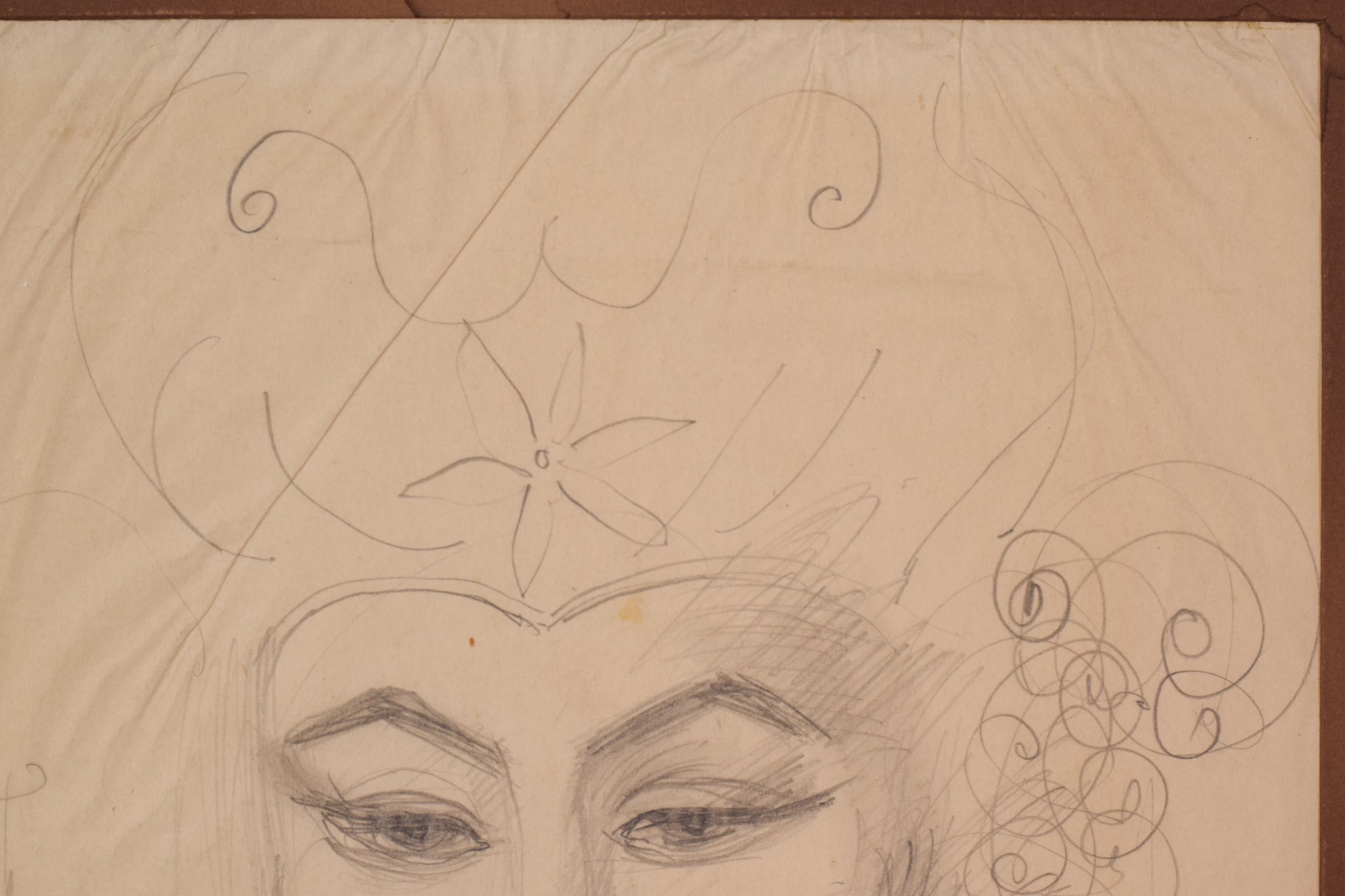 A drawing of a woman's face with a flower in her hair.