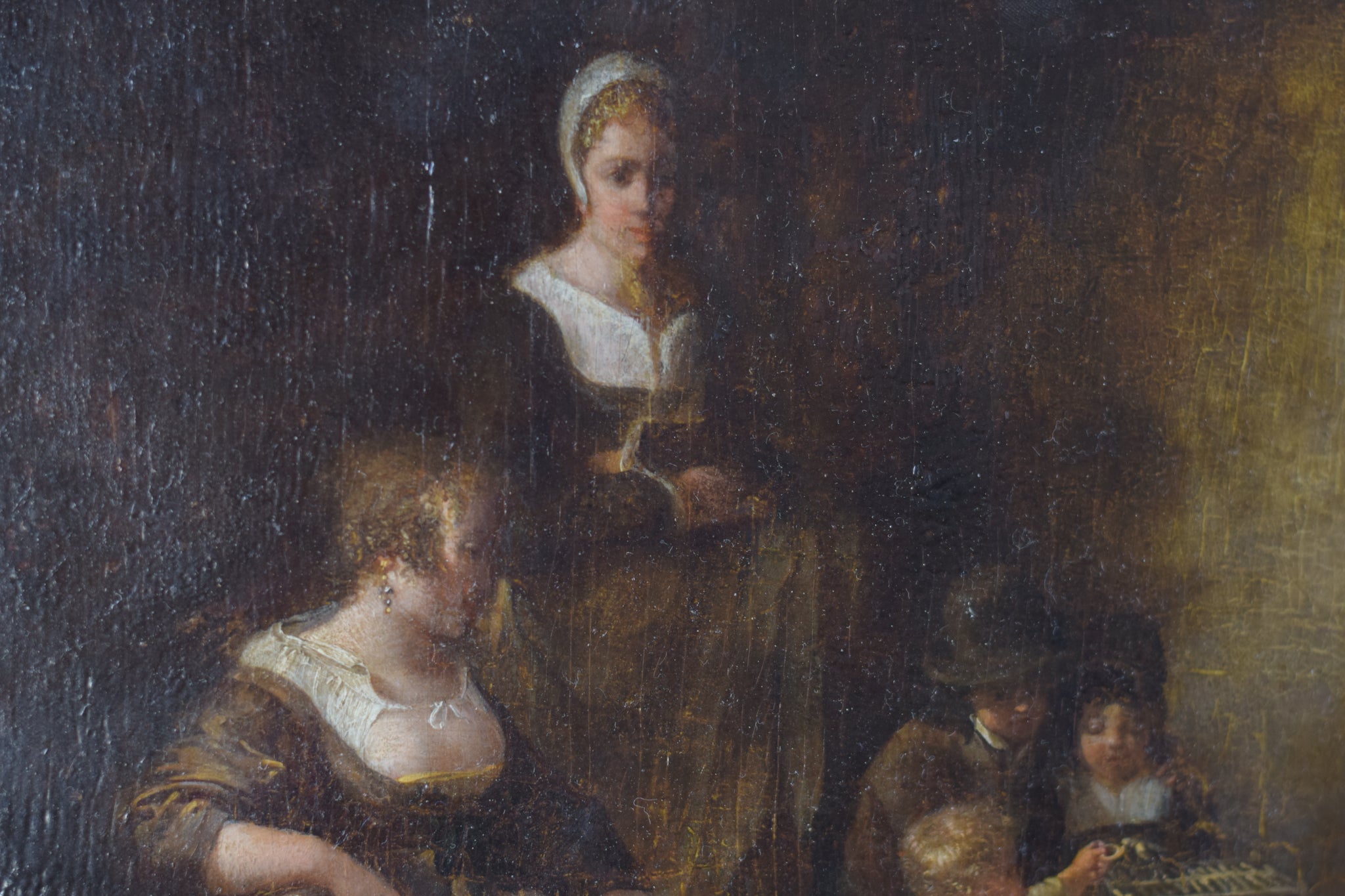 A painting of a woman sitting on a couch with two children.