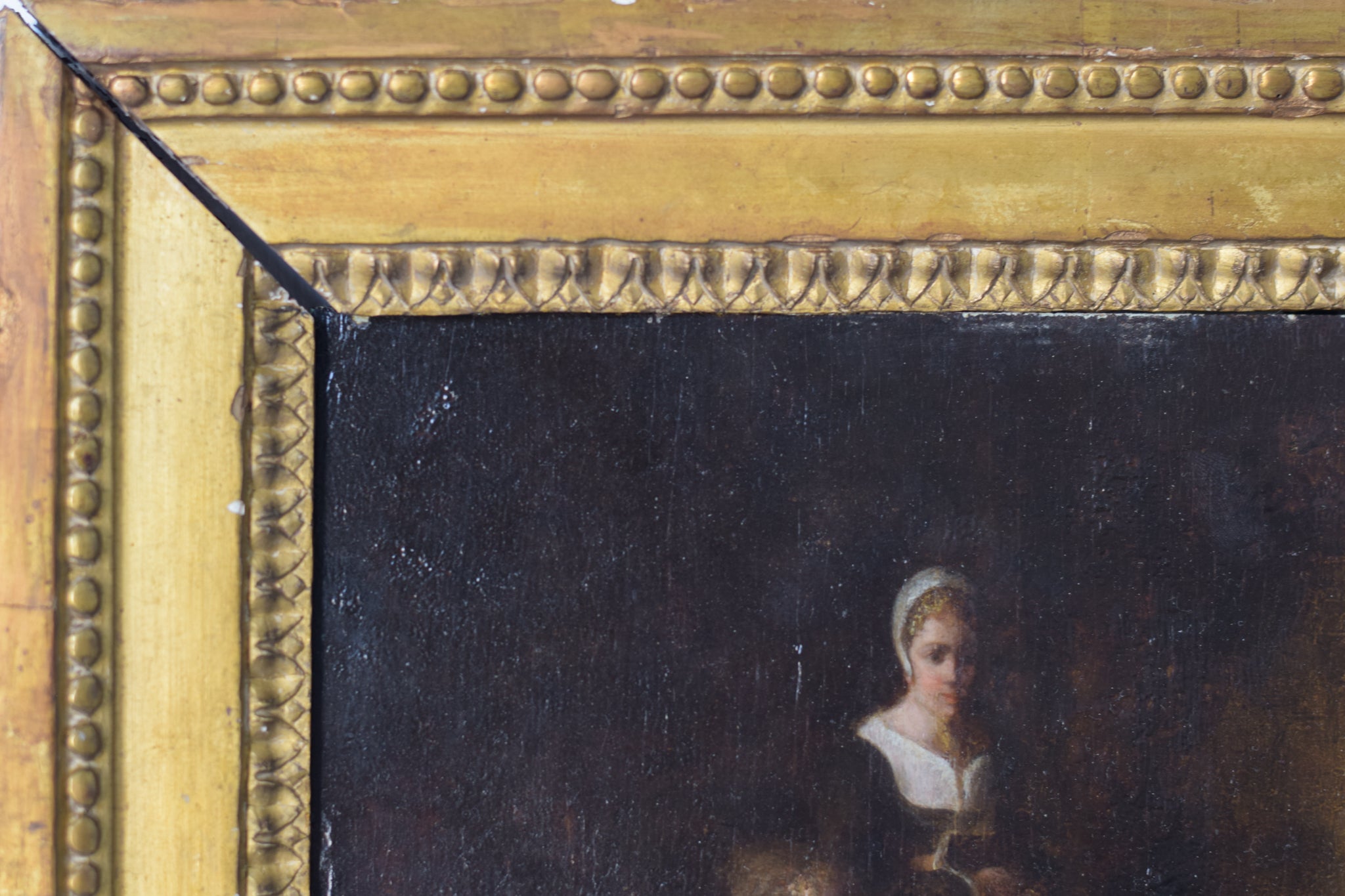 A painting of a woman sitting on a couch with two children.