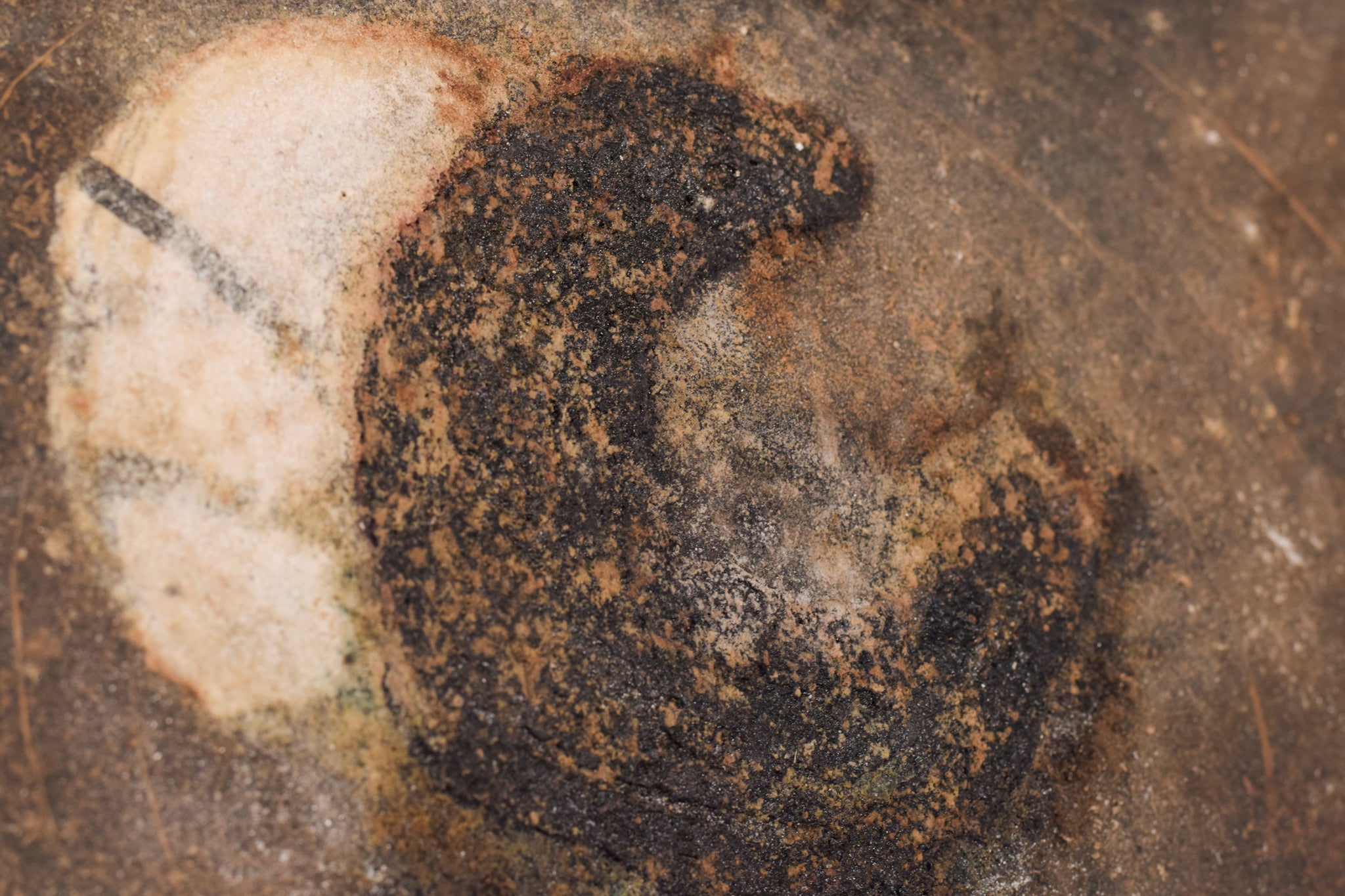 A close up of a piece of art on a wall.