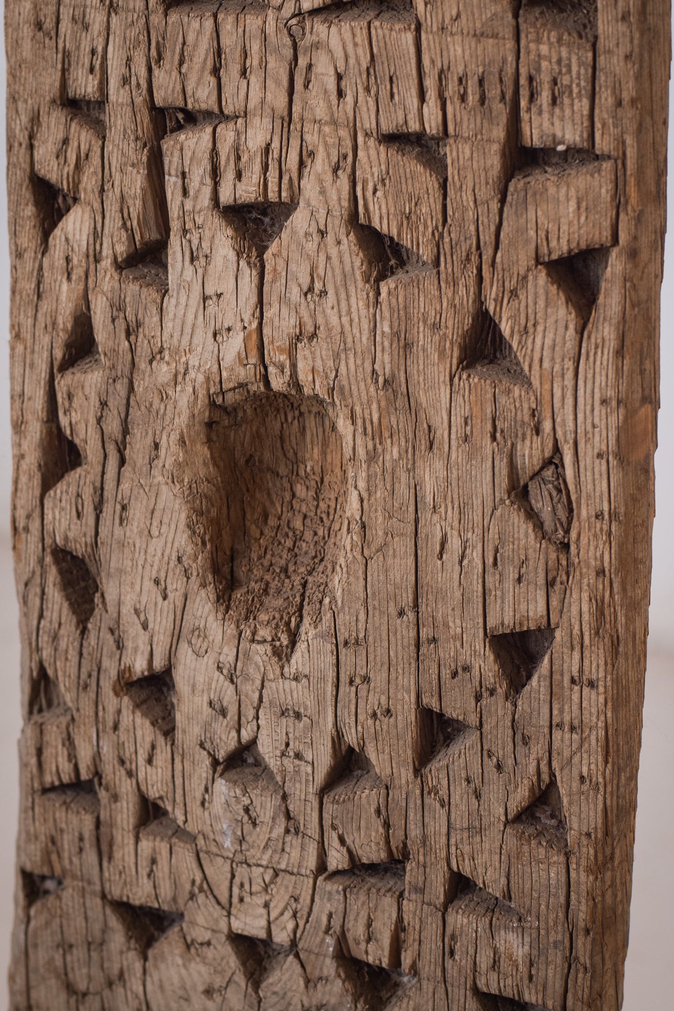 A large wooden sculpture on a metal stand.