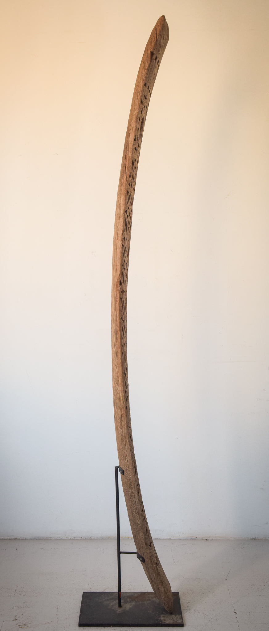 A large wooden sculpture on a metal stand.