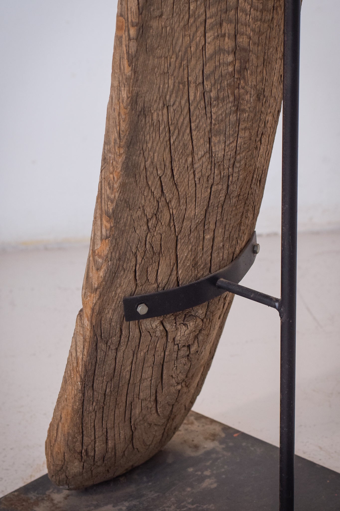 A large wooden sculpture on a metal stand.