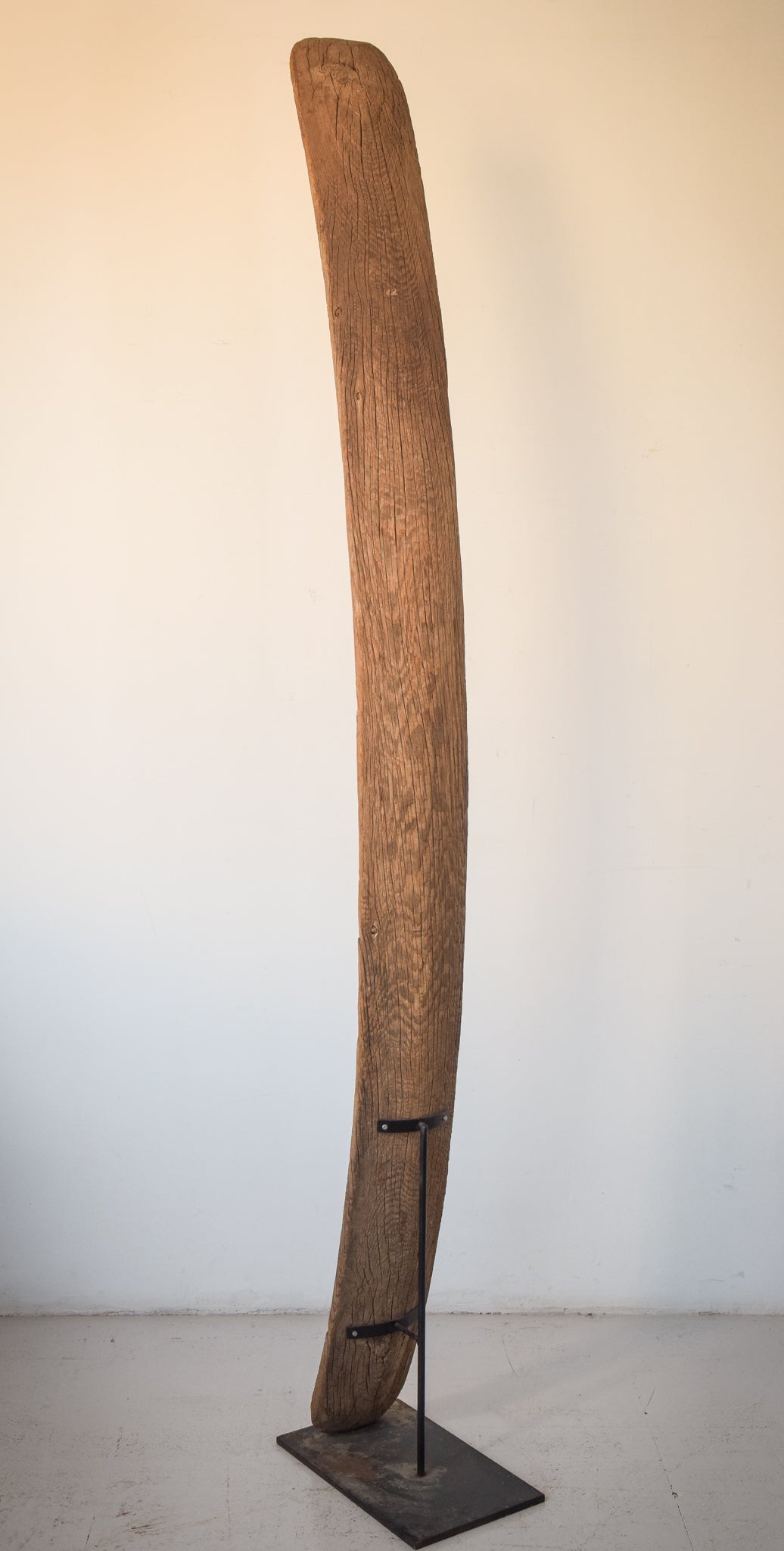 A large wooden sculpture on a metal stand.