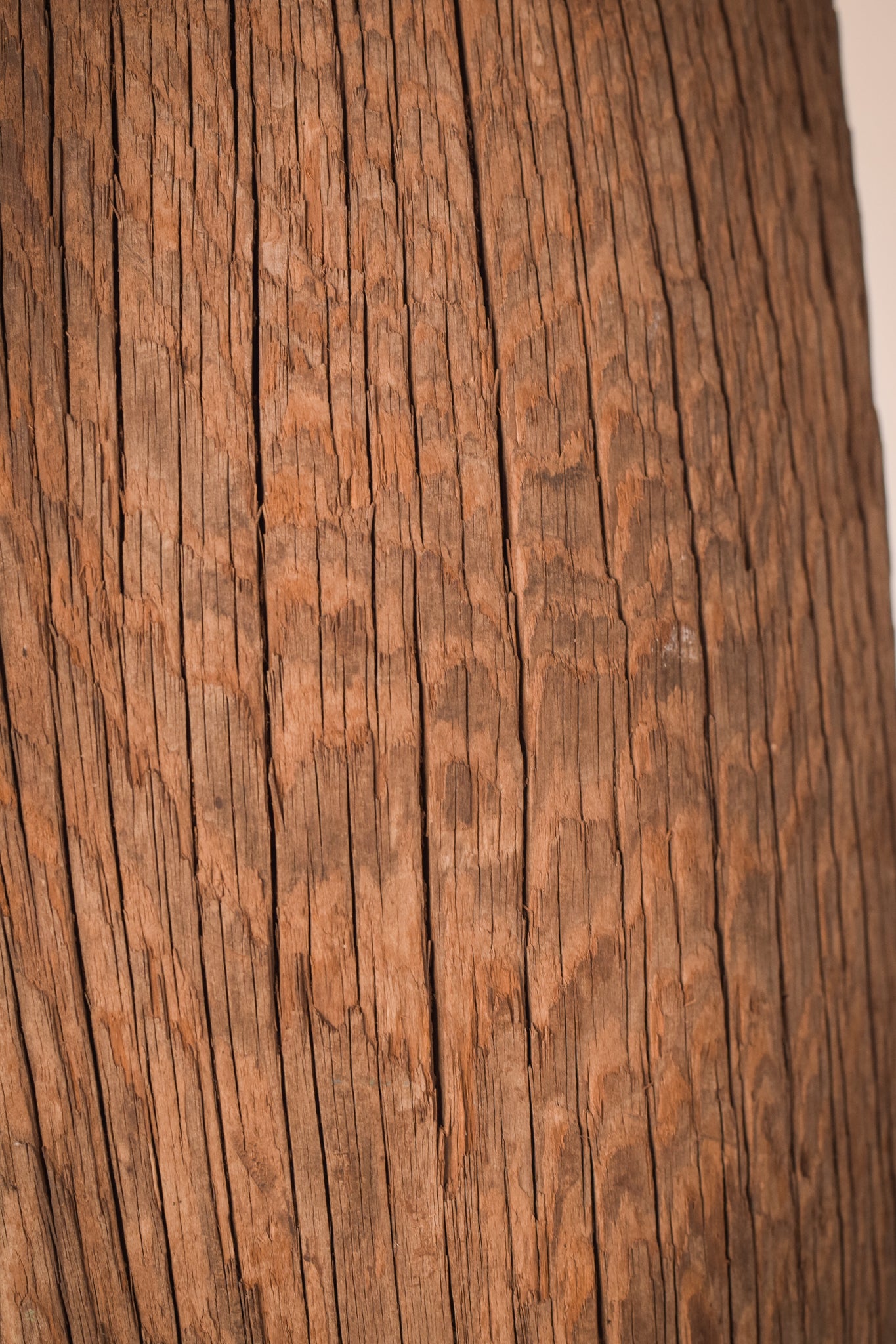 A large wooden sculpture on a metal stand.