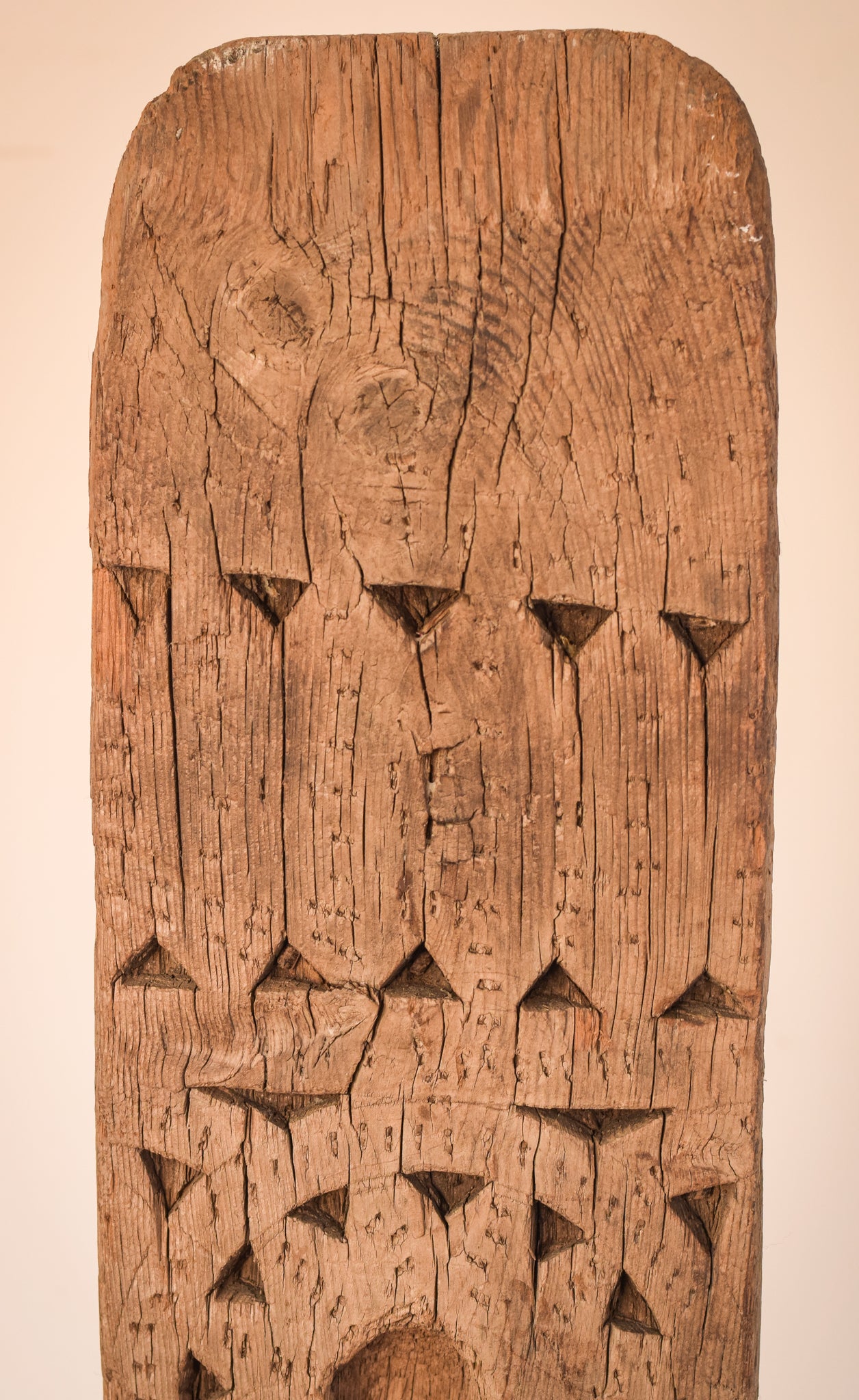 A large wooden sculpture on a metal stand.