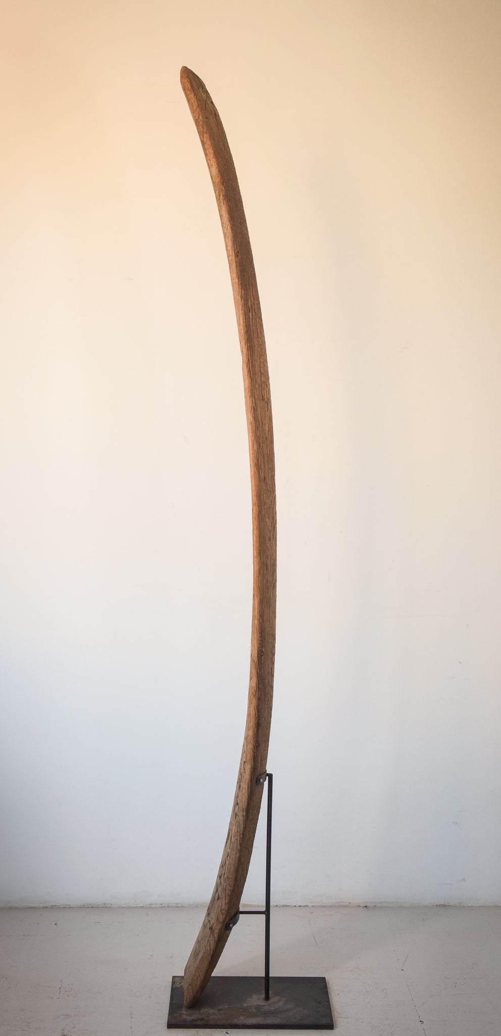 A large wooden sculpture on a metal stand.