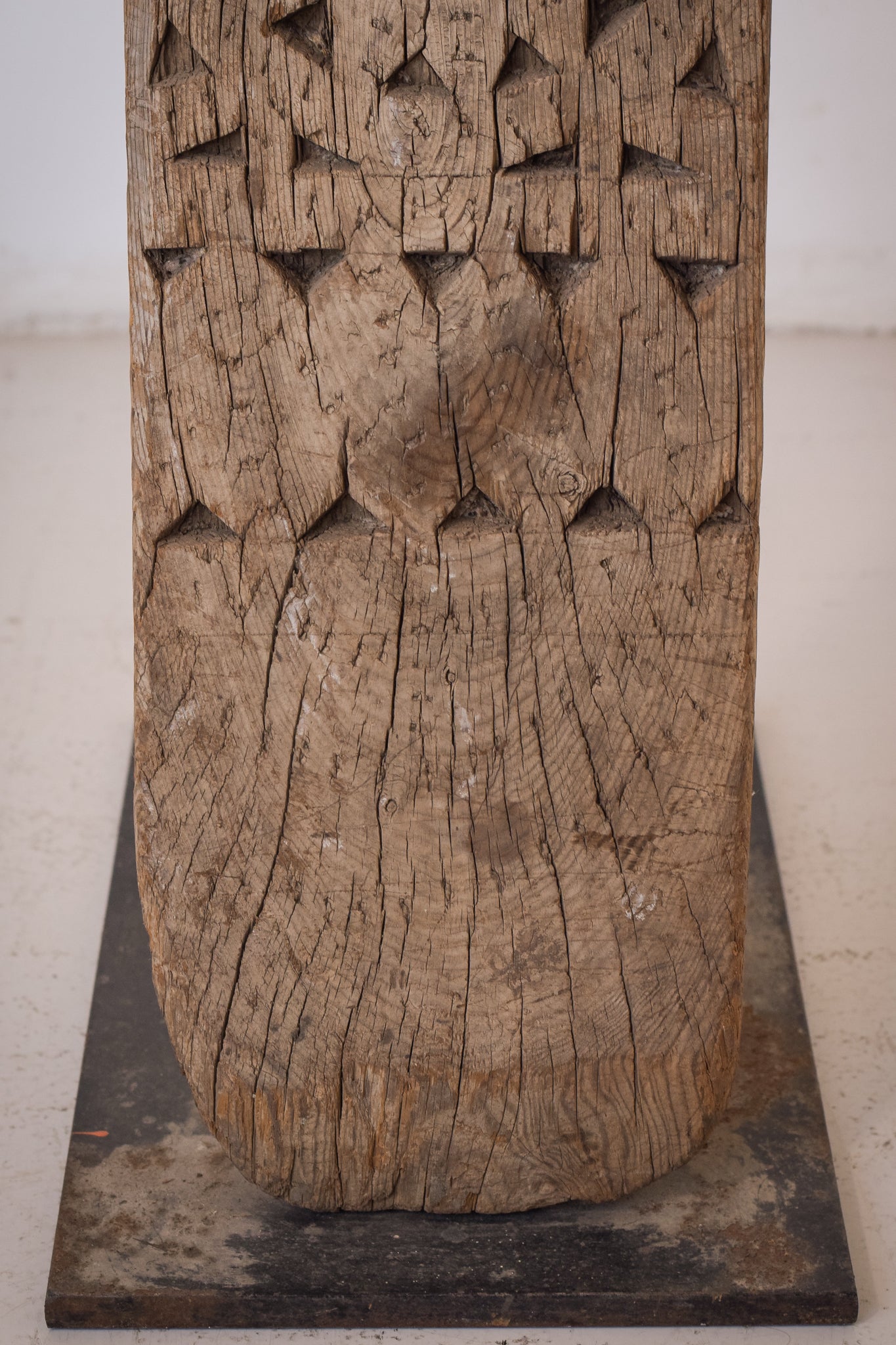 A large wooden sculpture on a metal stand.