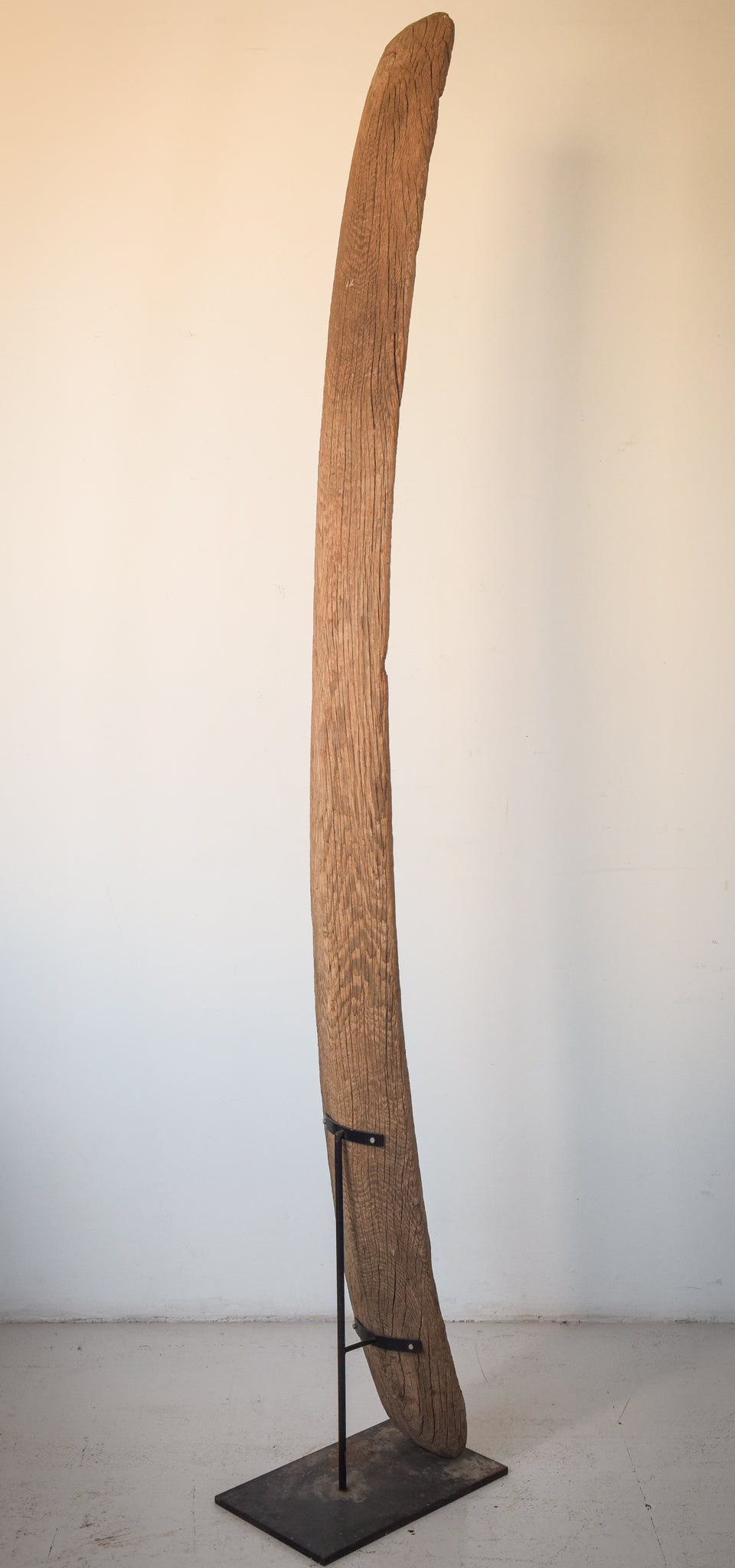 A large wooden sculpture on a metal stand.