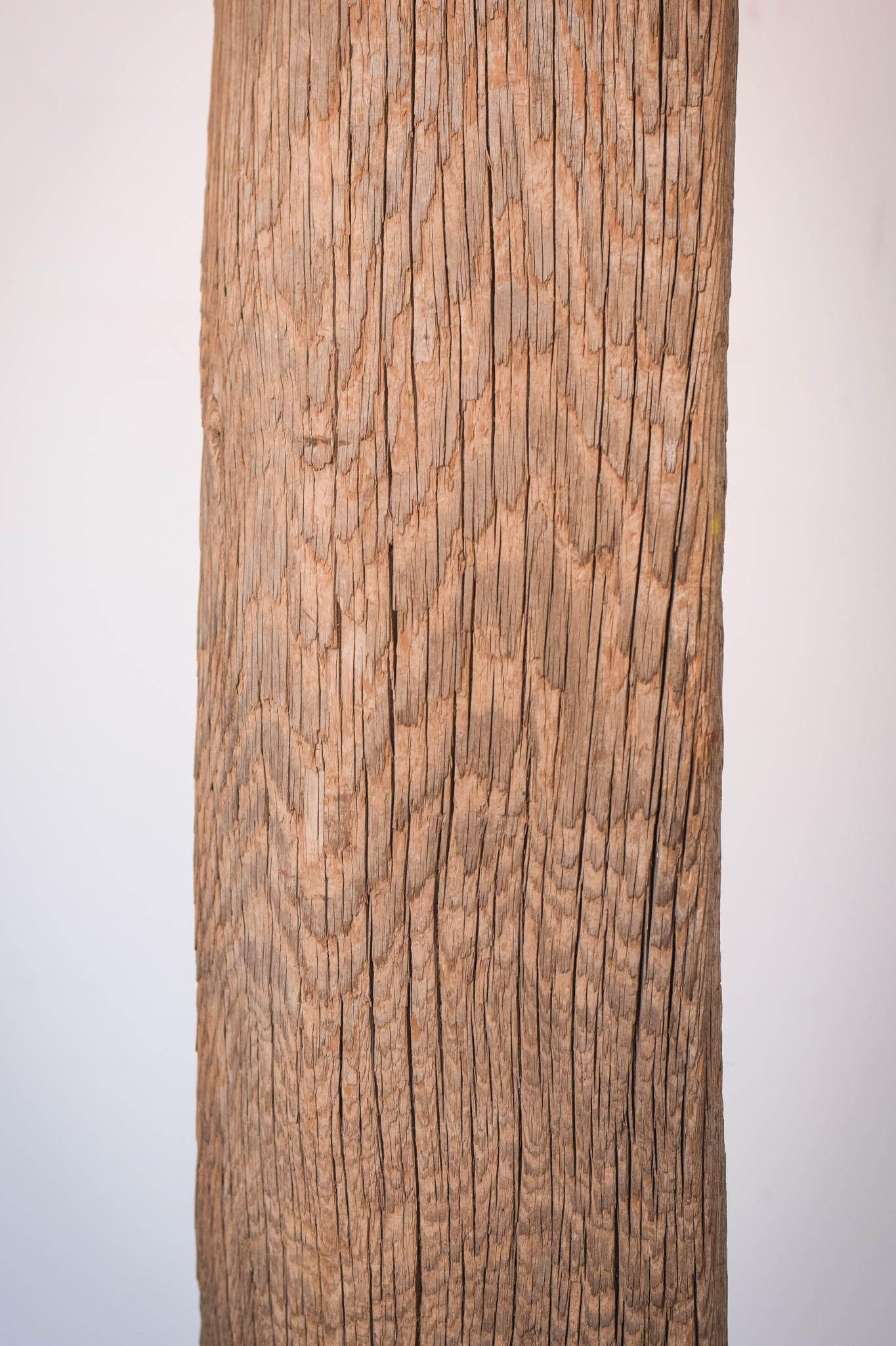 A large wooden sculpture on a metal stand.