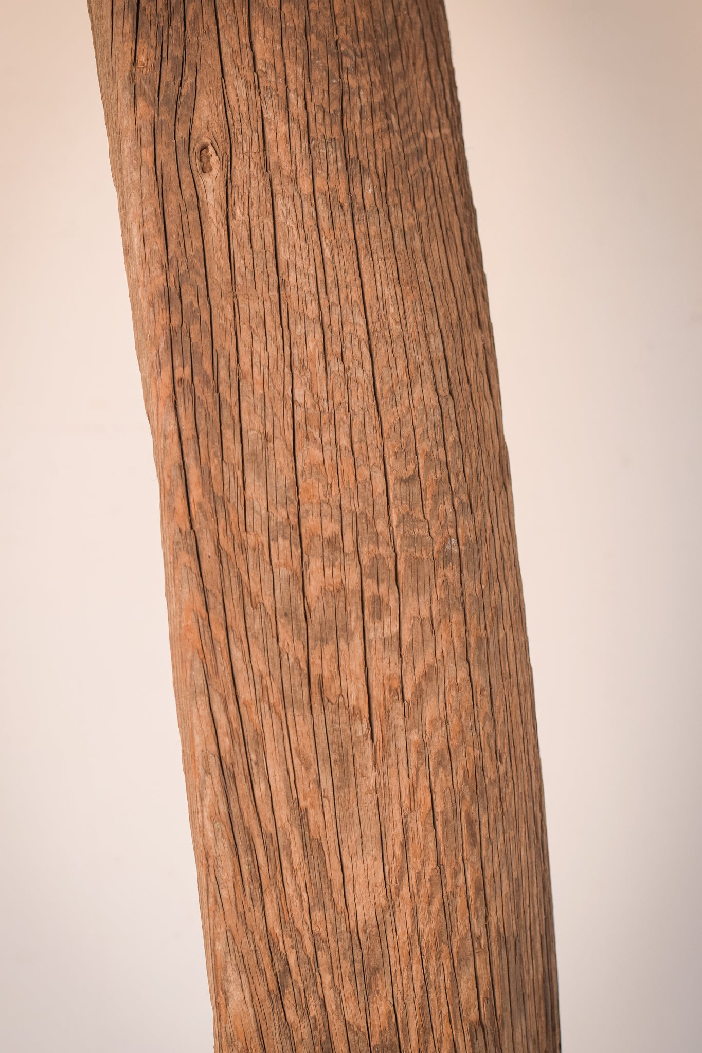 A large wooden sculpture on a metal stand.