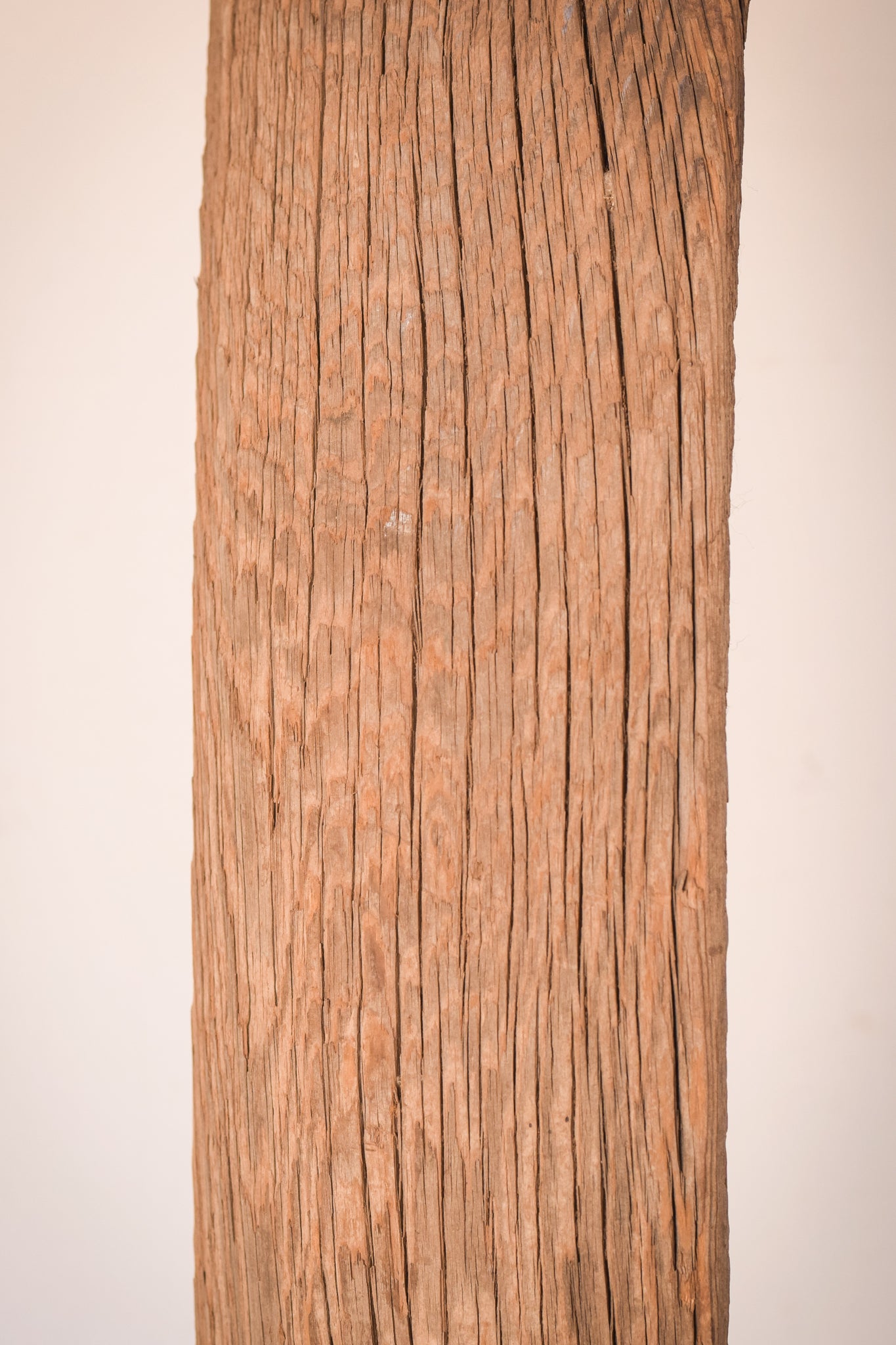 A large wooden sculpture on a metal stand.