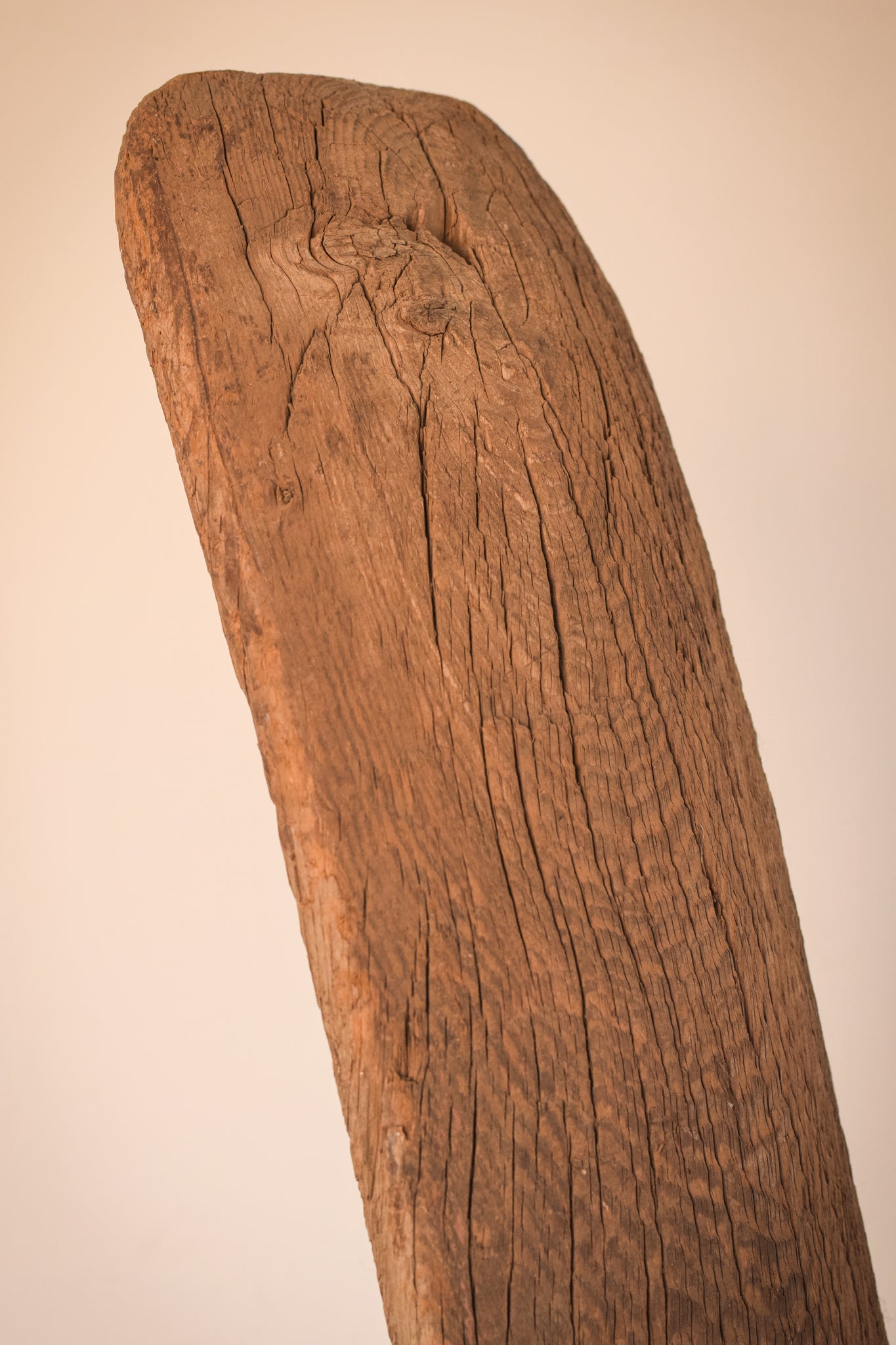 A large wooden sculpture on a metal stand.