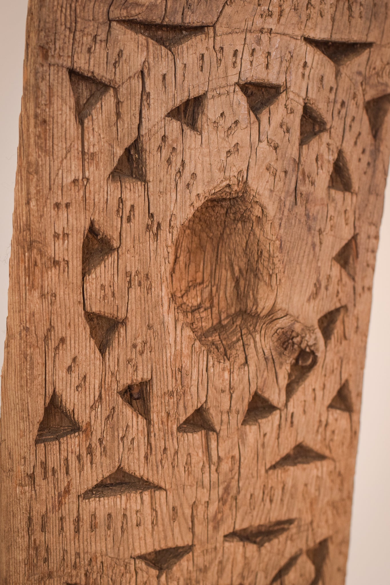 A large wooden sculpture on a metal stand.