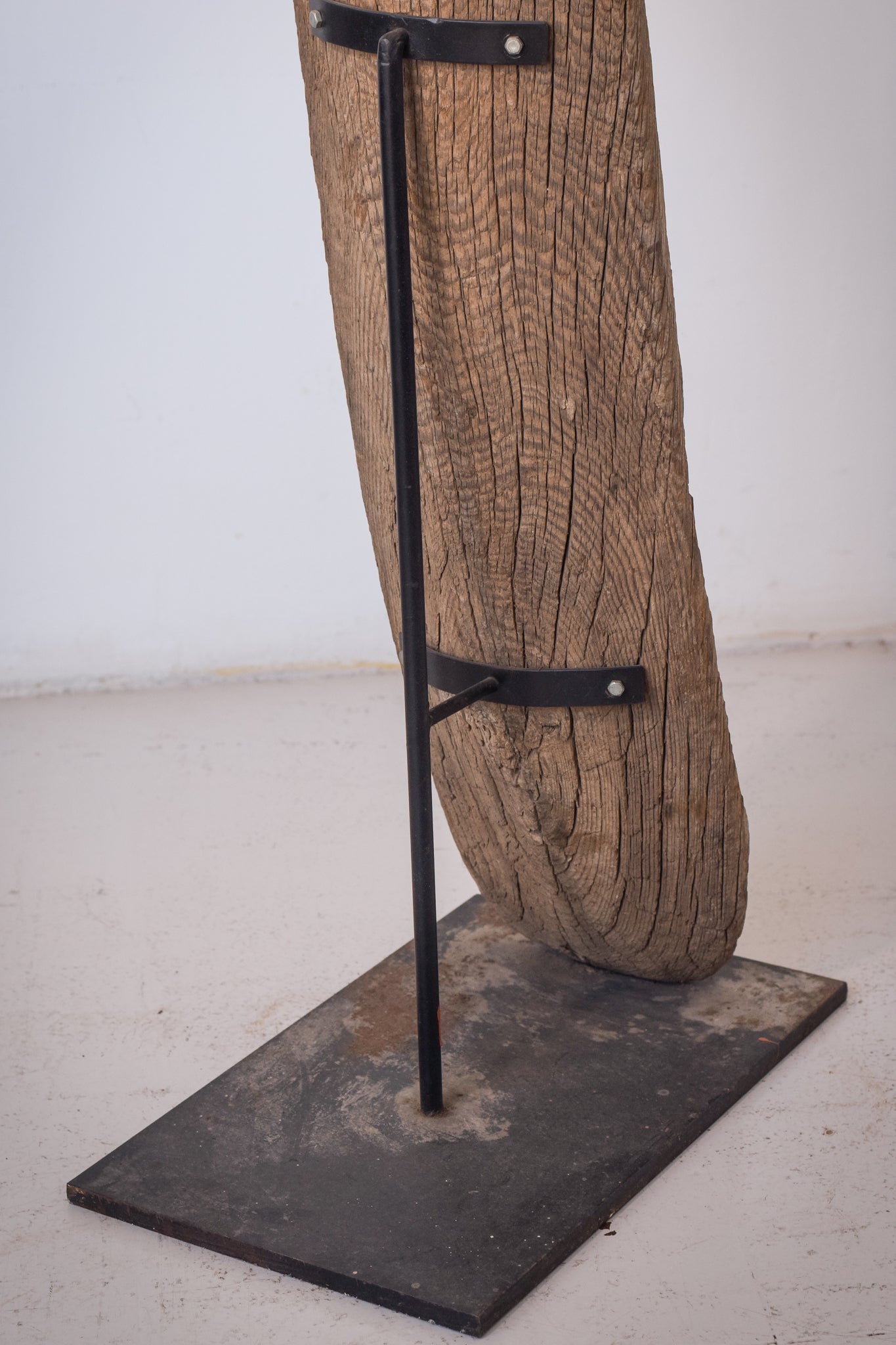 A large wooden sculpture on a metal stand.