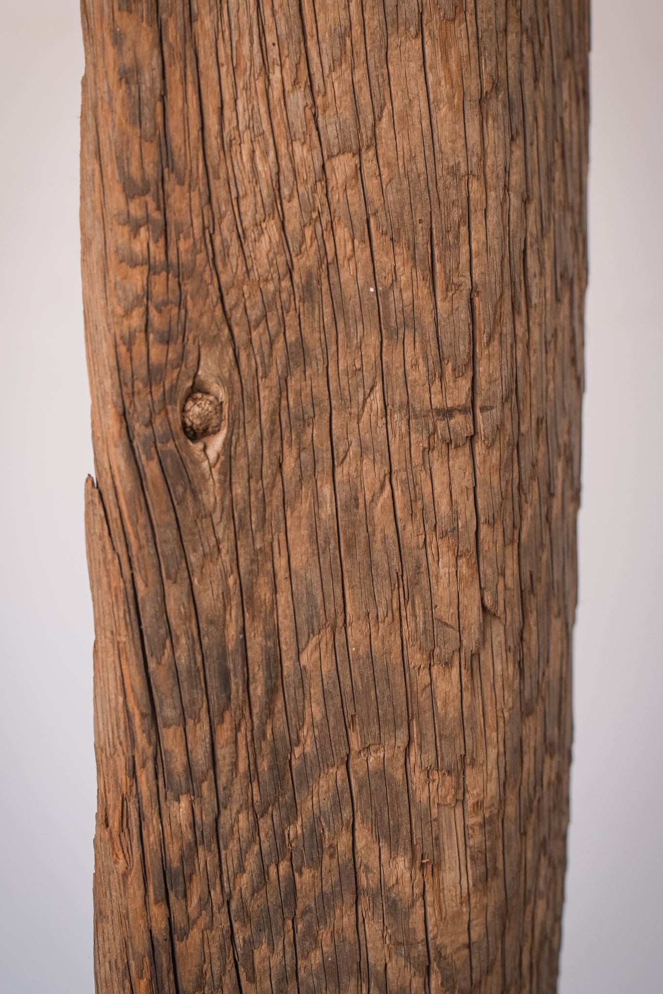 A large wooden sculpture on a metal stand.