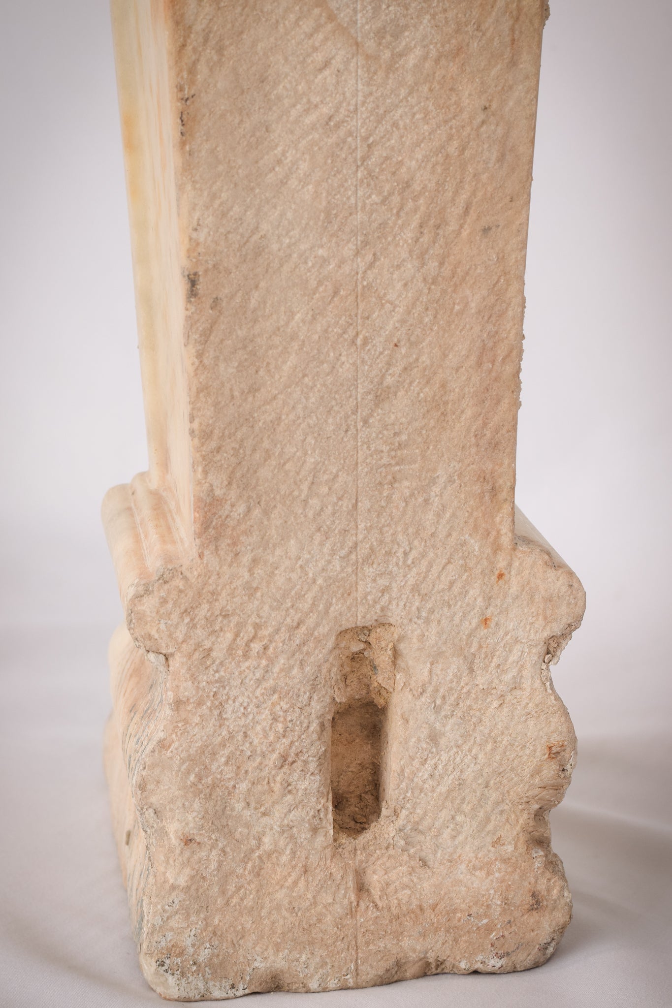 A white marble column with a leaf design on it.