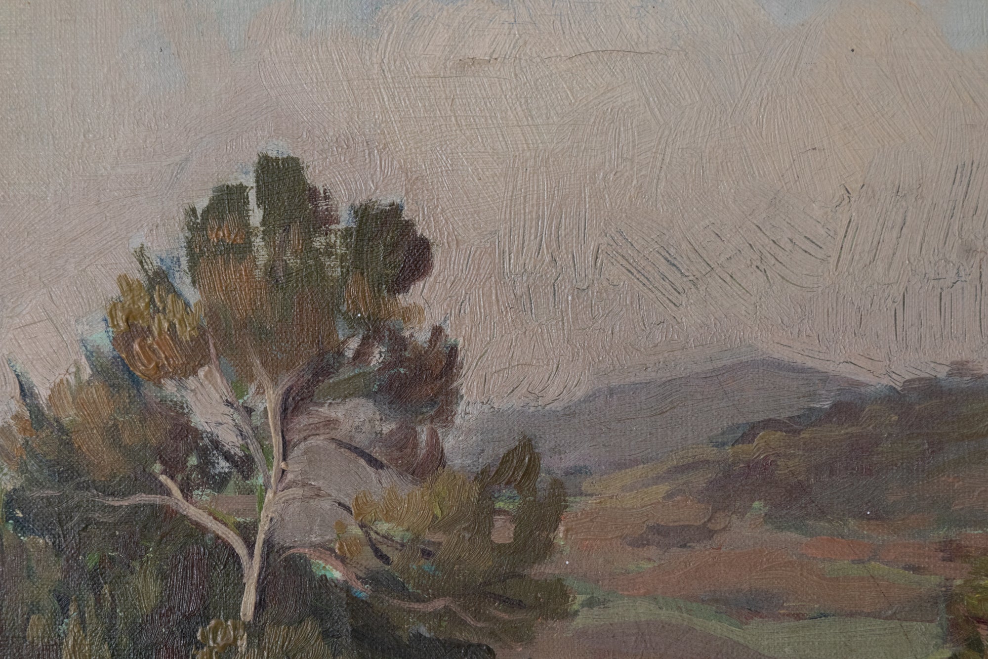 A painting of a landscape with trees in the foreground.