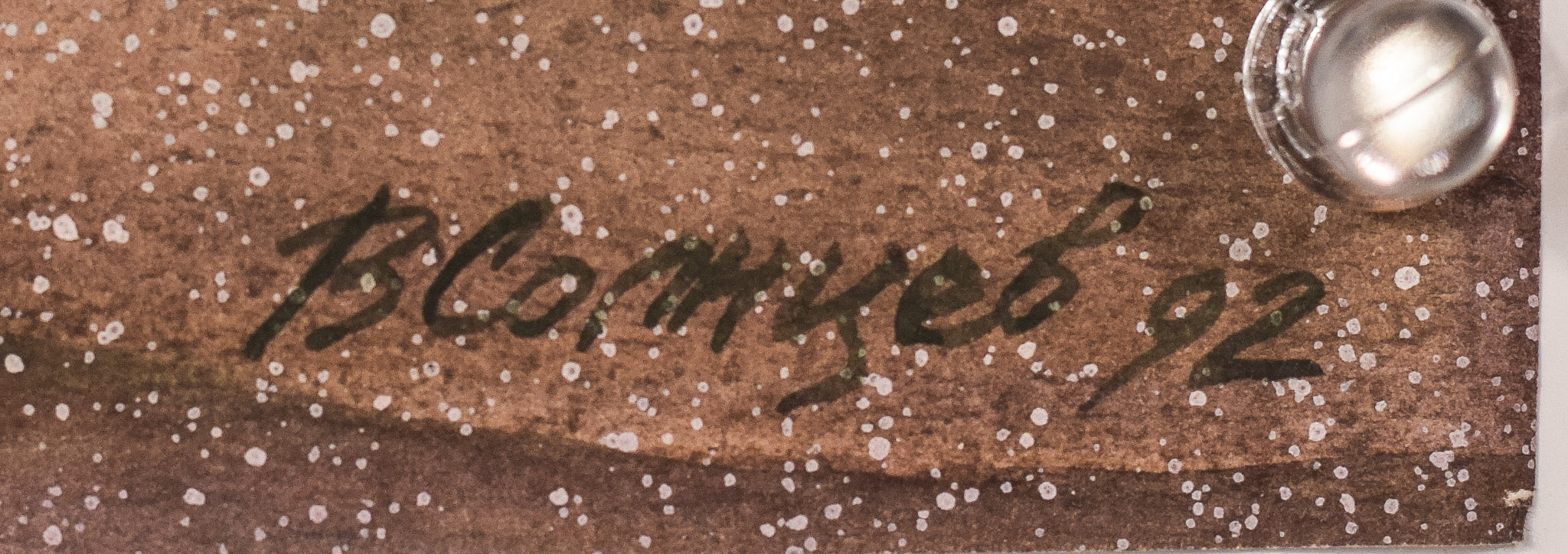 A painting of a snowy street with trees and a bridge.