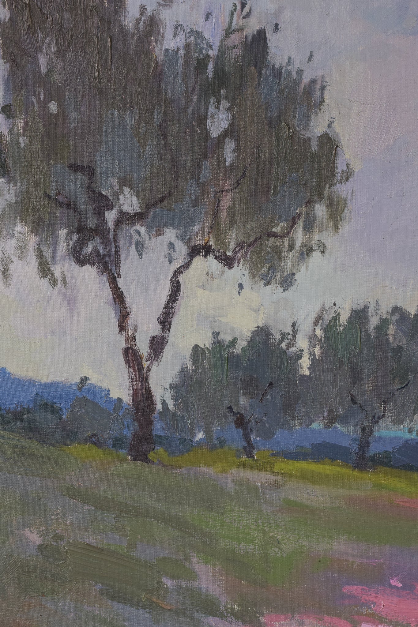 A painting of a landscape with trees in the distance.