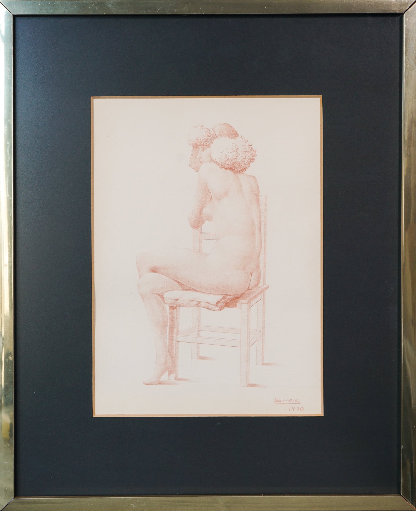 A drawing of a nude woman sitting on a chair.