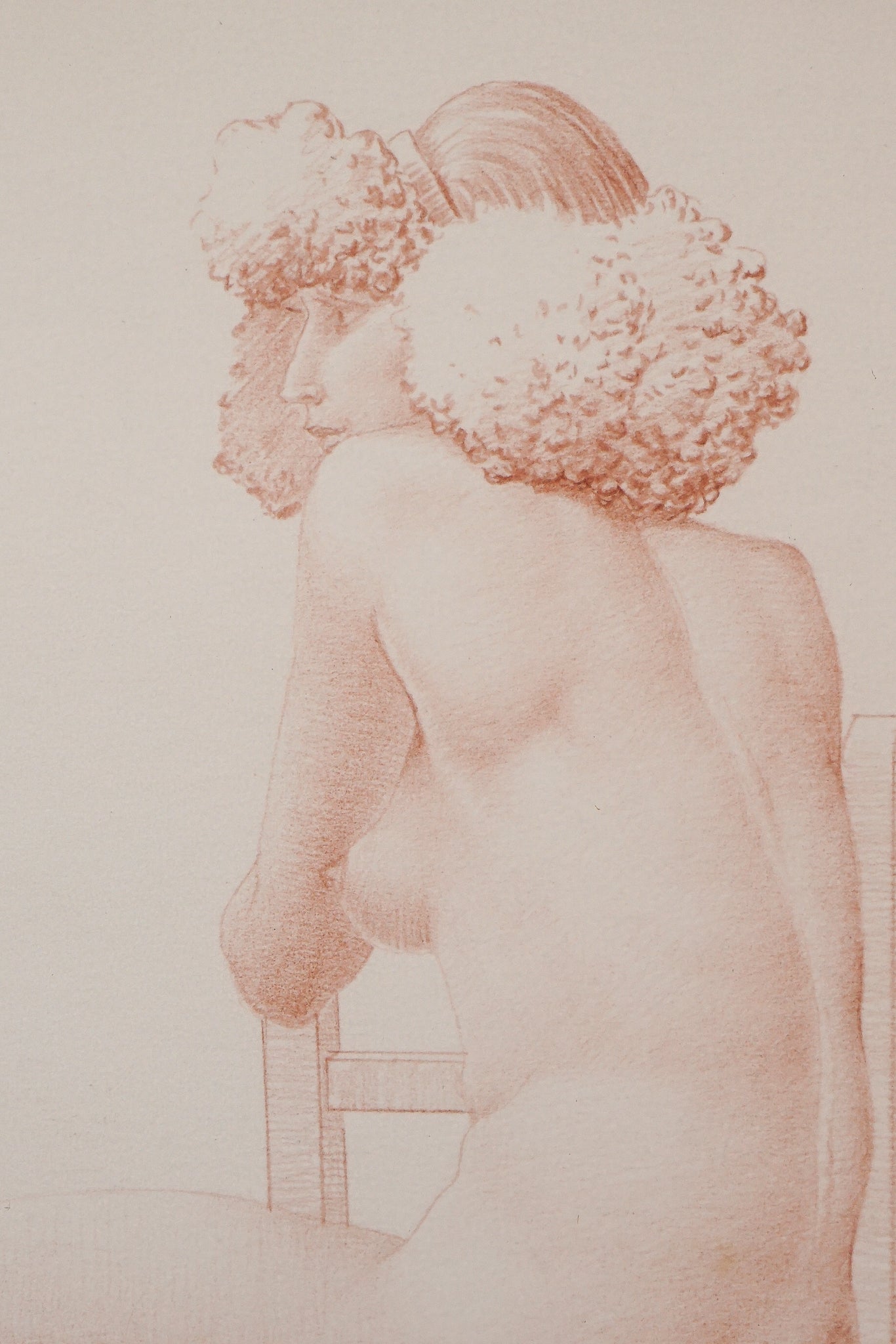 A drawing of a nude woman sitting on a chair.