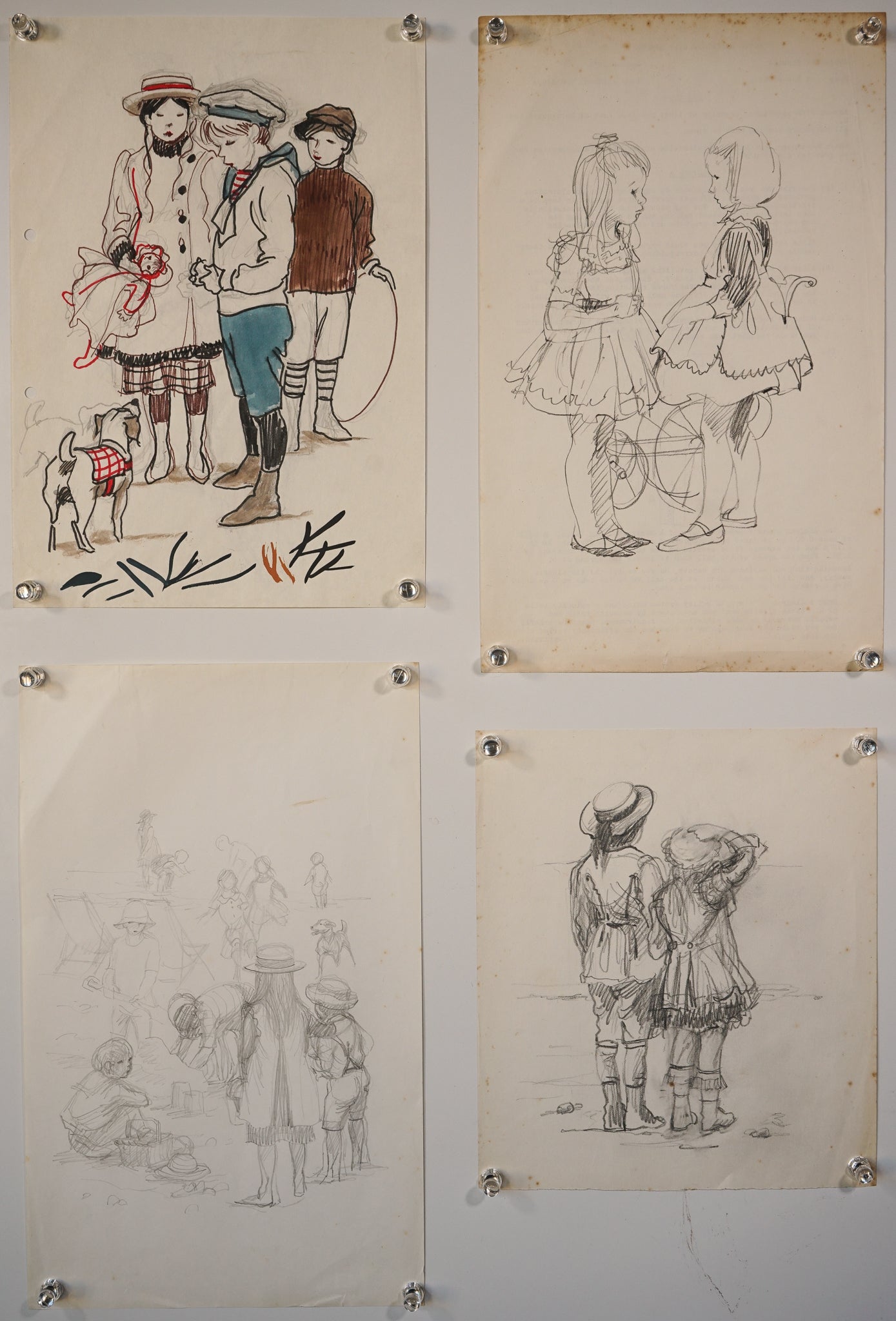A group of four drawings hanging on a wall.