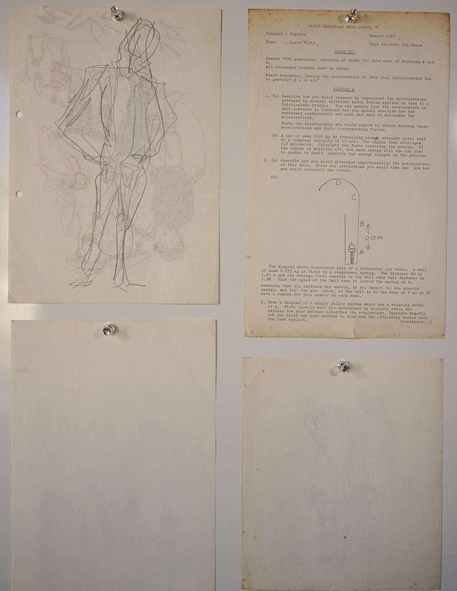 A group of four drawings hanging on a wall.