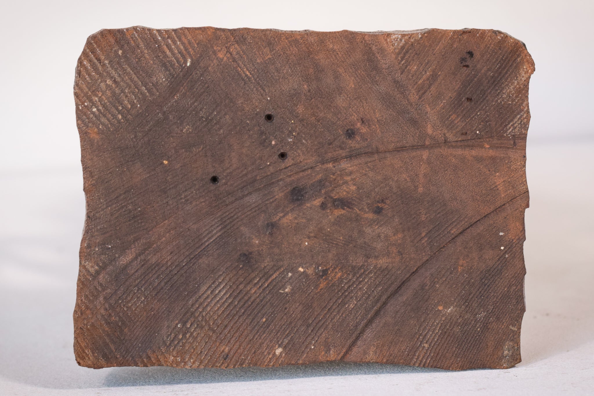 A wooden statue of a man with a cane and a hat.