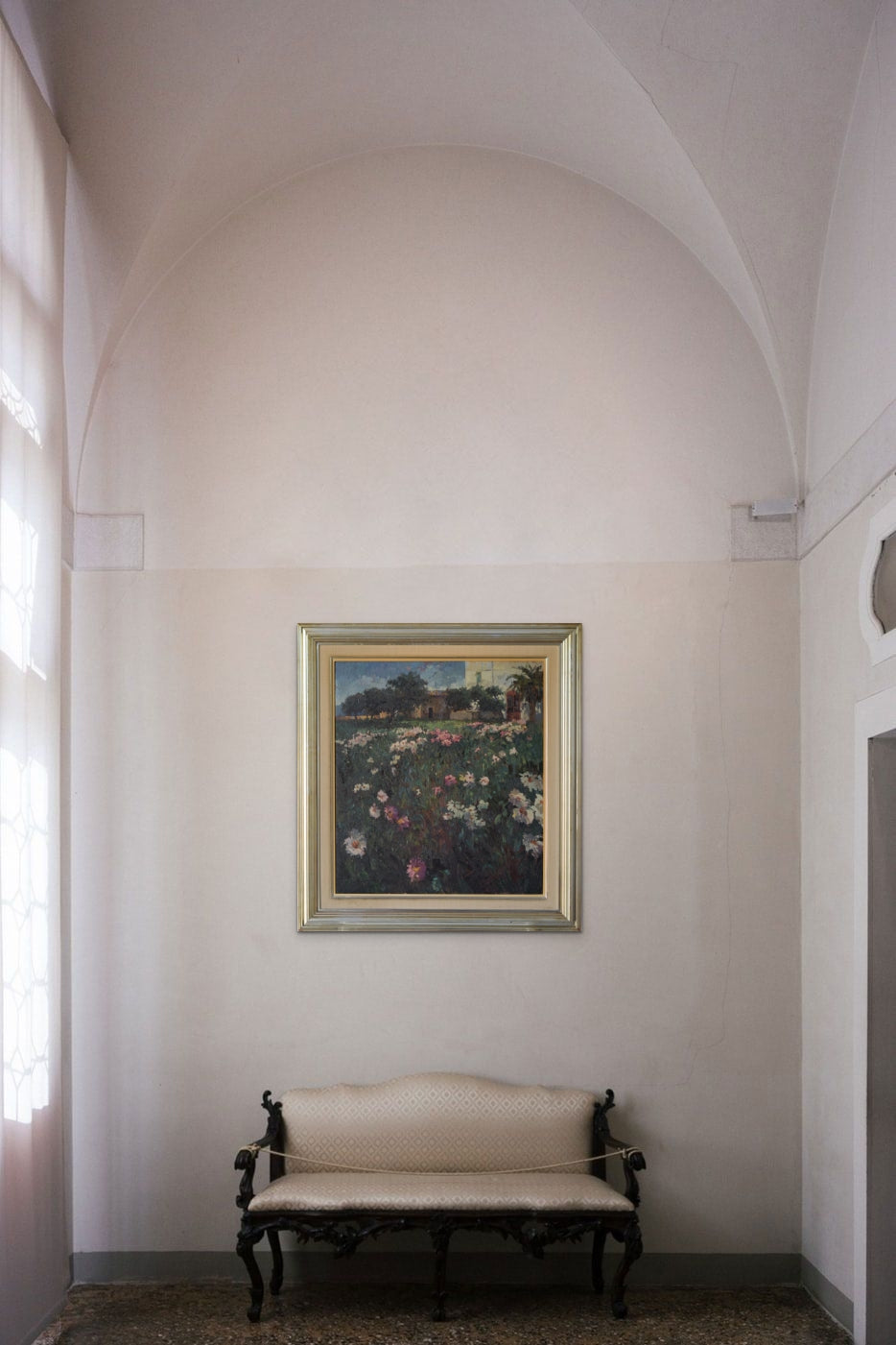 A painting of a field of flowers in front of a building.