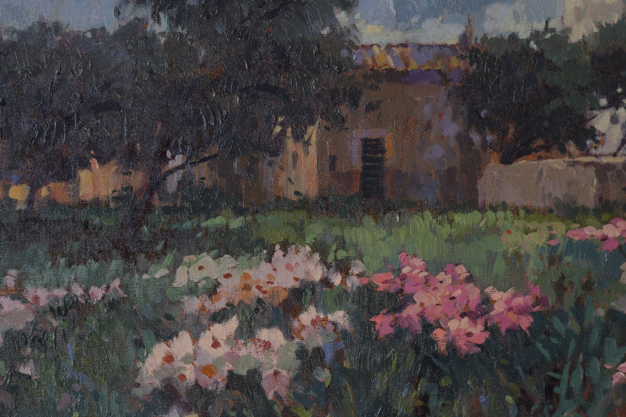 A painting of a field of flowers in front of a building.