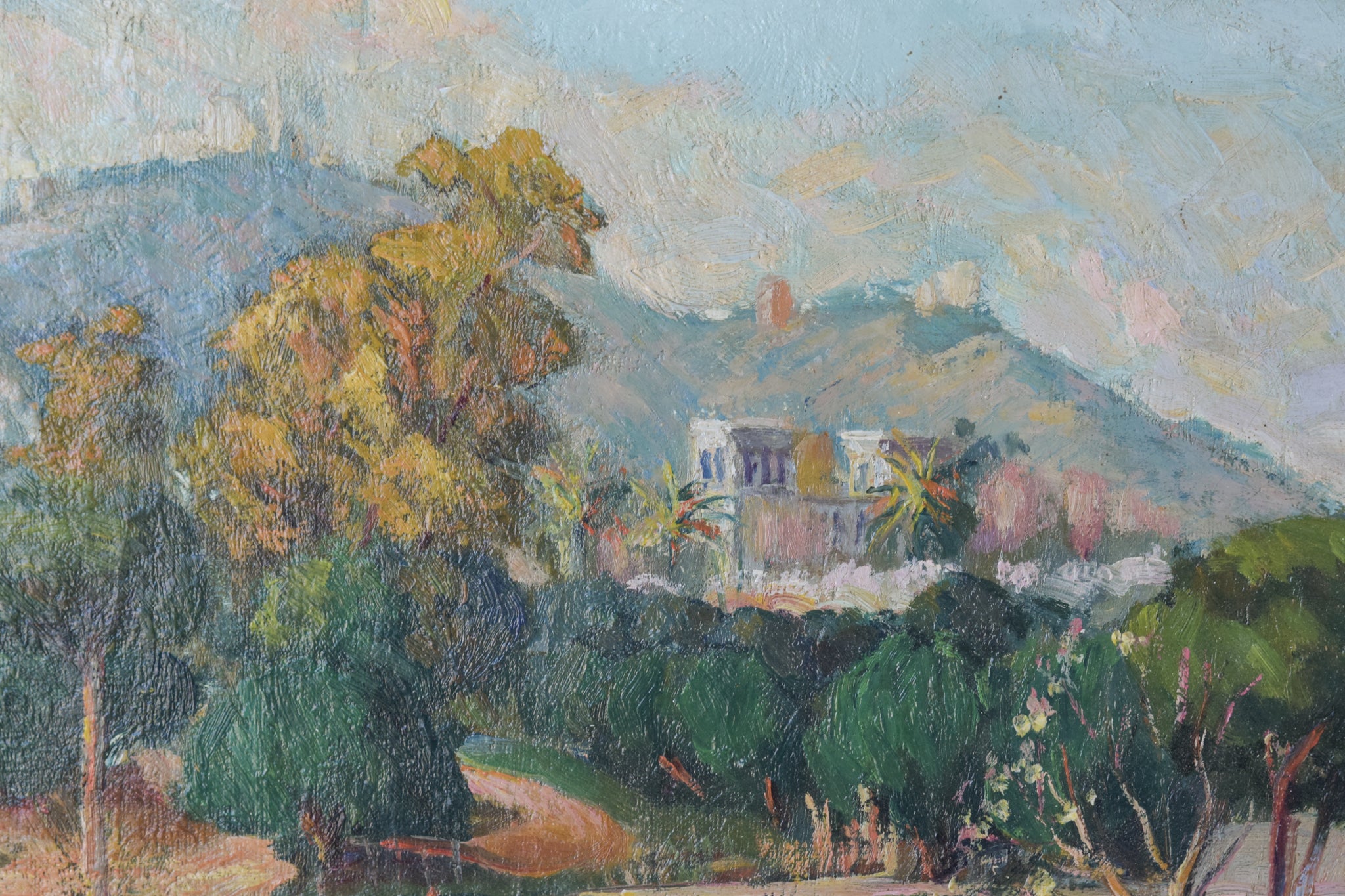 A painting of a landscape with trees and mountains in the background.