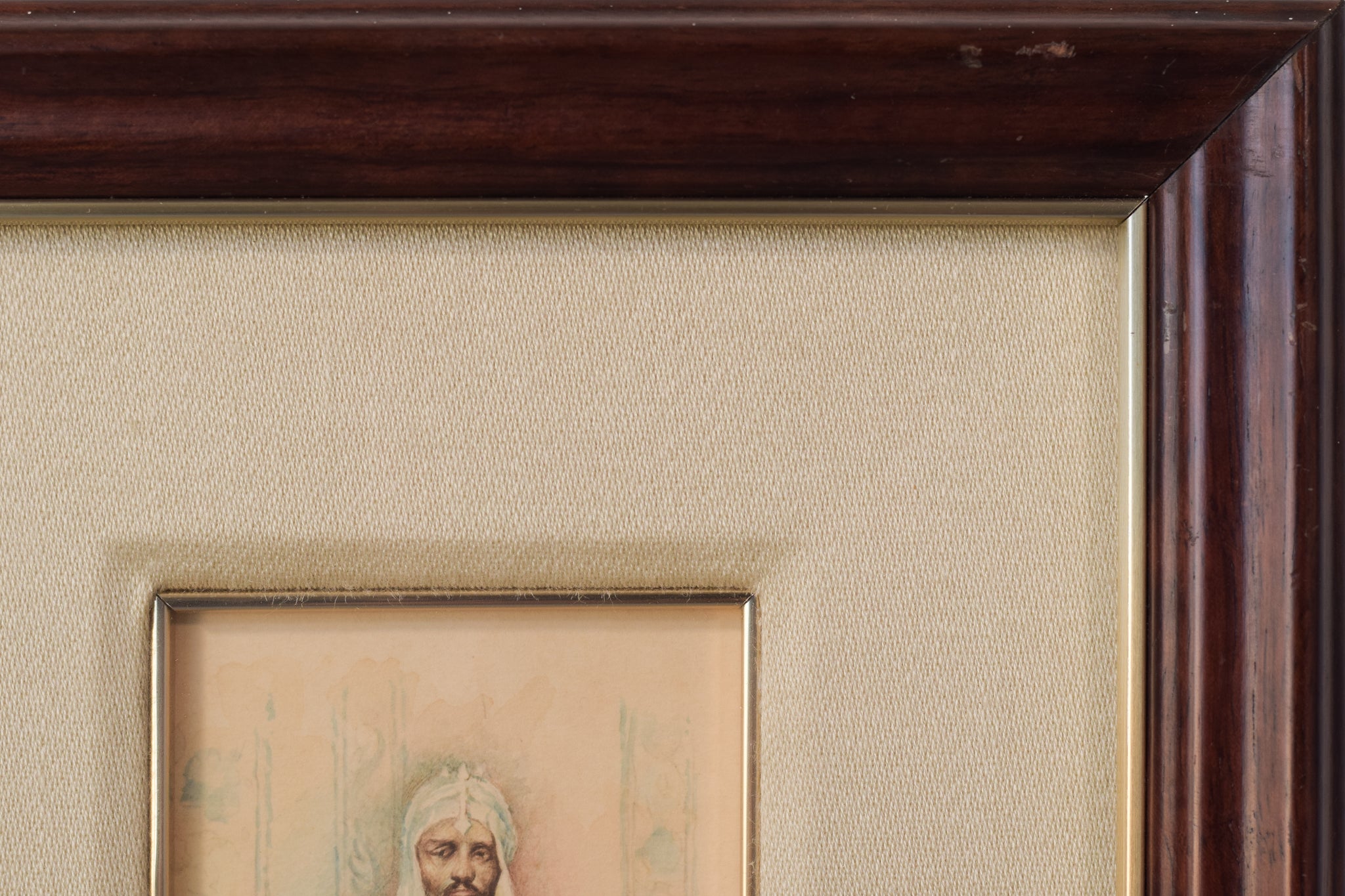 A watercolor painting of a man in a turban sitting in a chair.