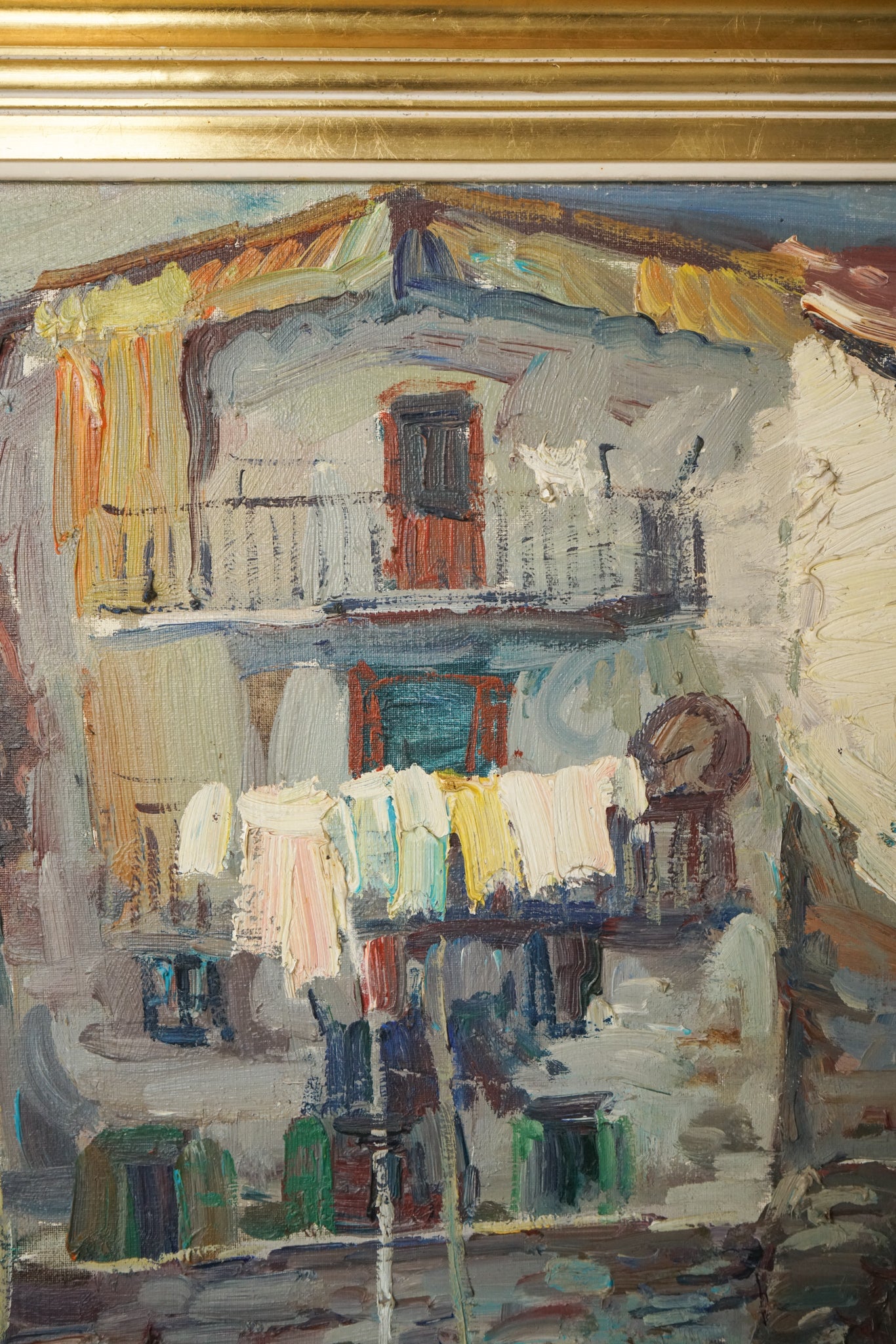 A painting of boats docked in a harbor next to buildings.