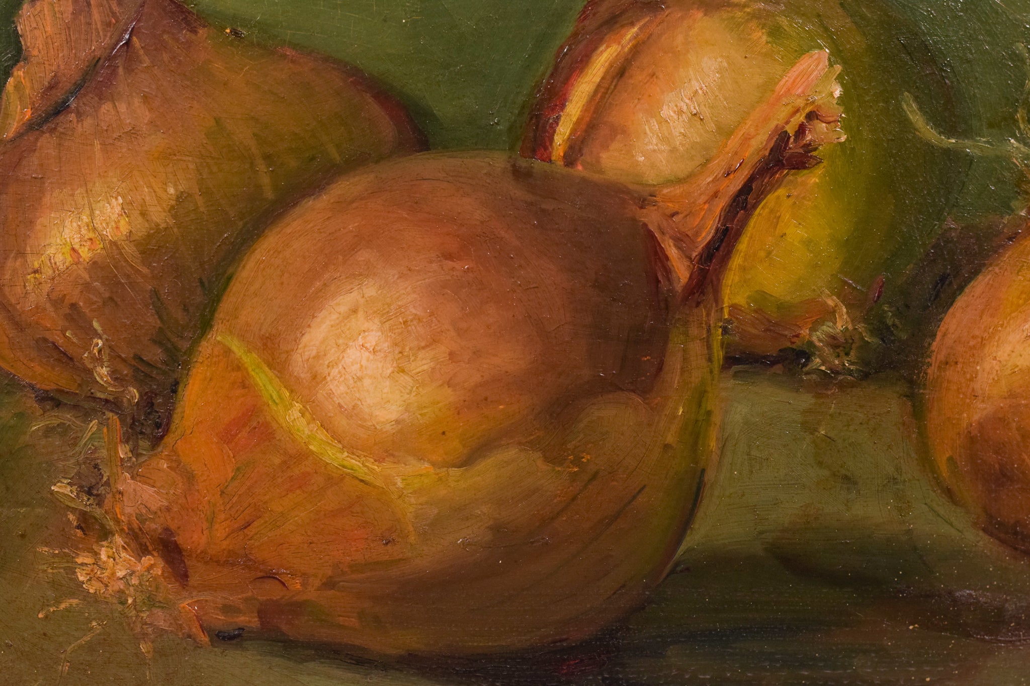 A painting of three onions on a green surface.