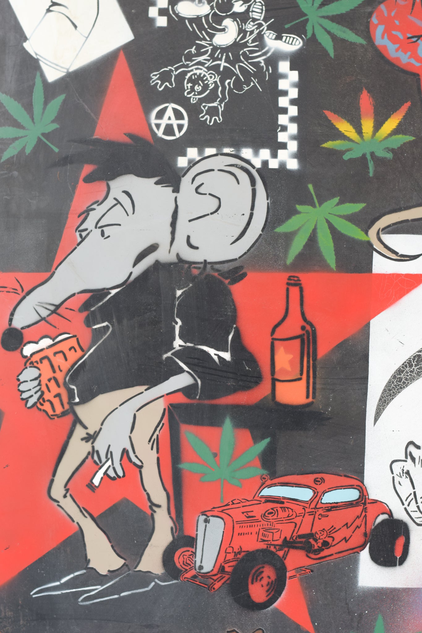 A wall covered in lots of different types of graffiti.