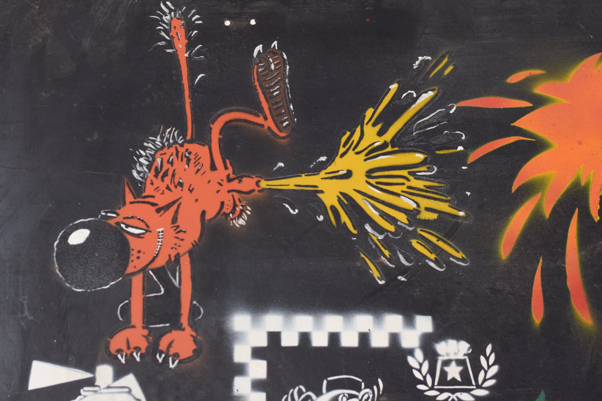 A wall covered in lots of different types of graffiti.