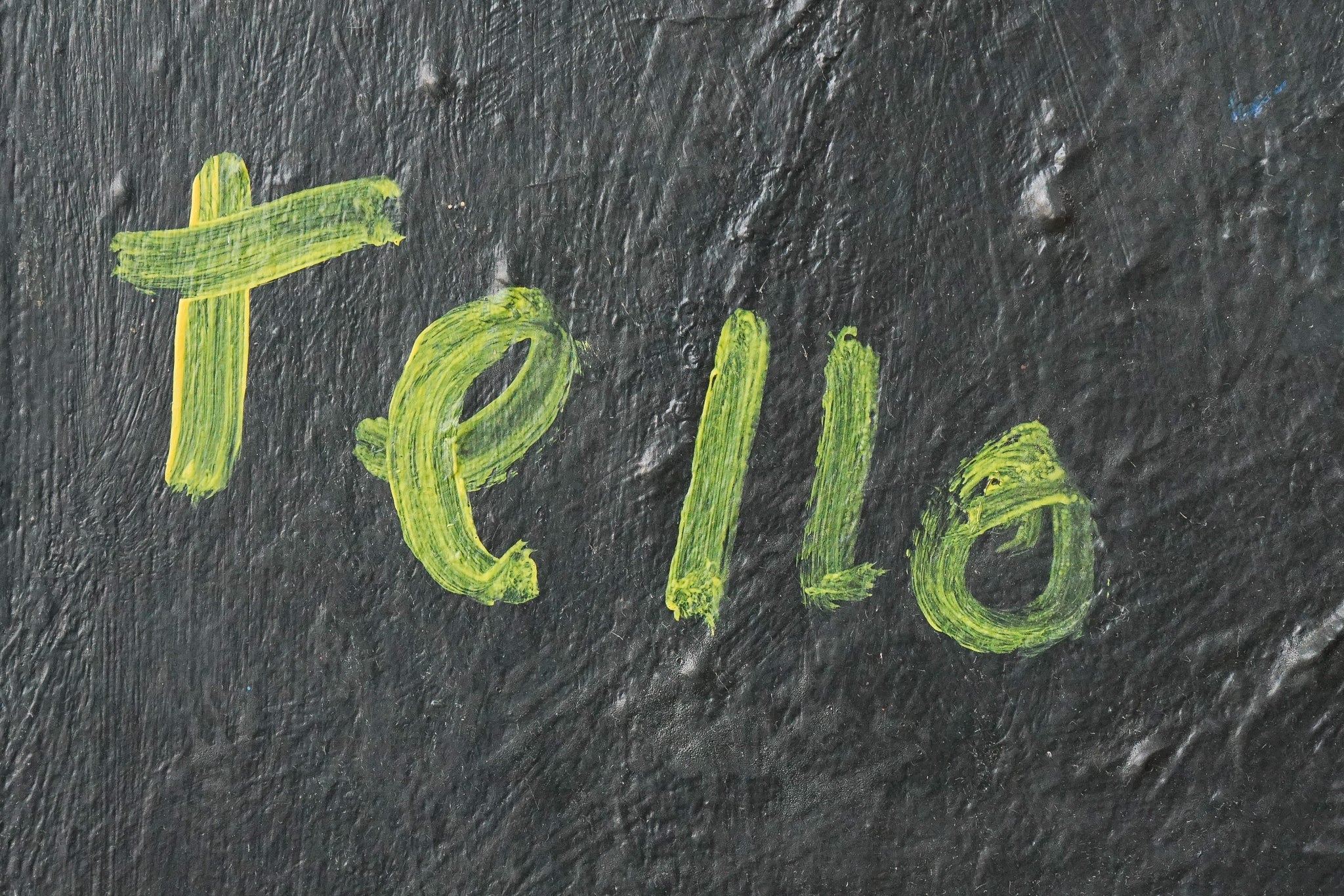 A painting of a woman's face on a black background.