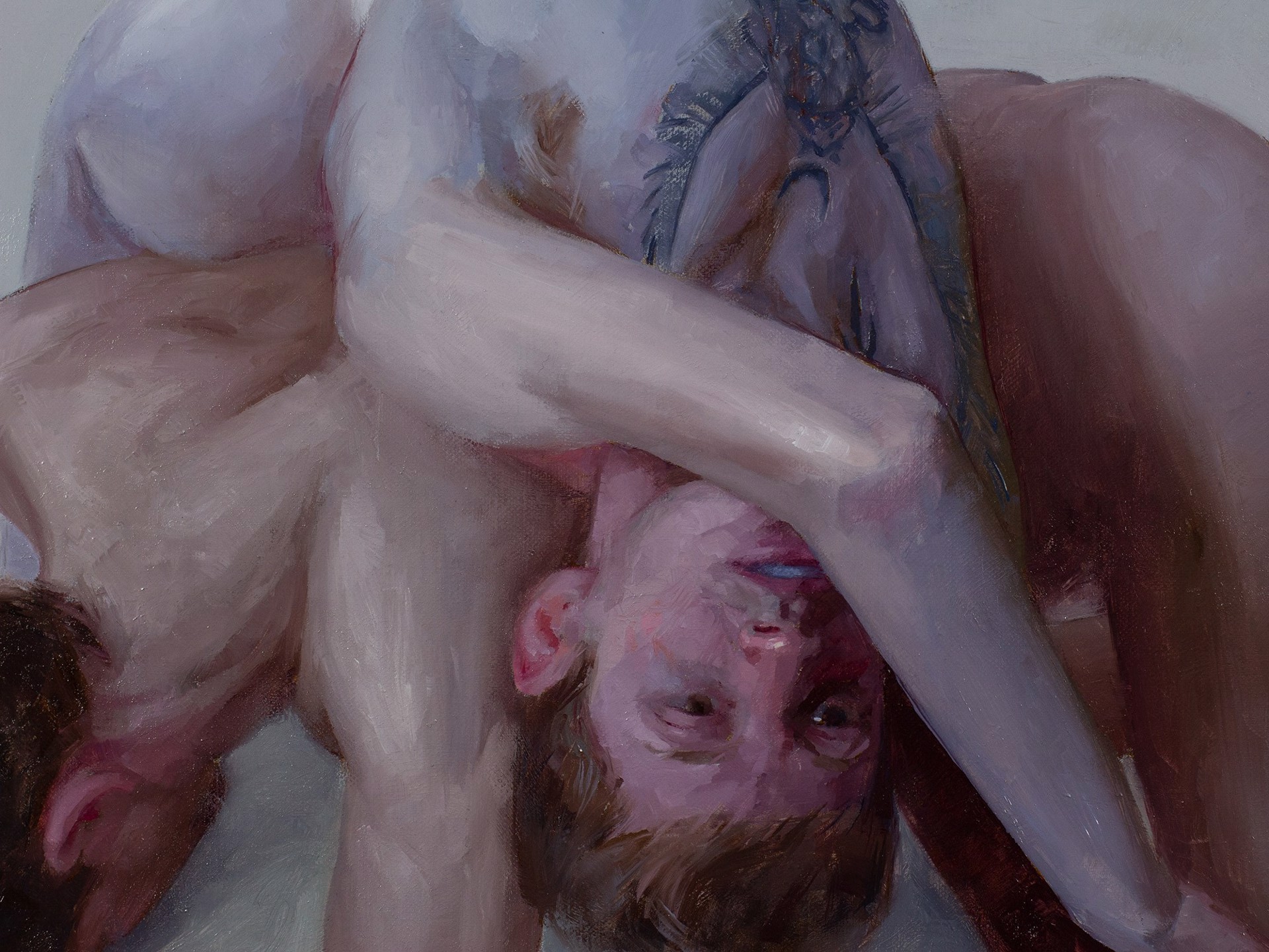 A nude figure is depicted in a contorted, intimate pose on a plain background.