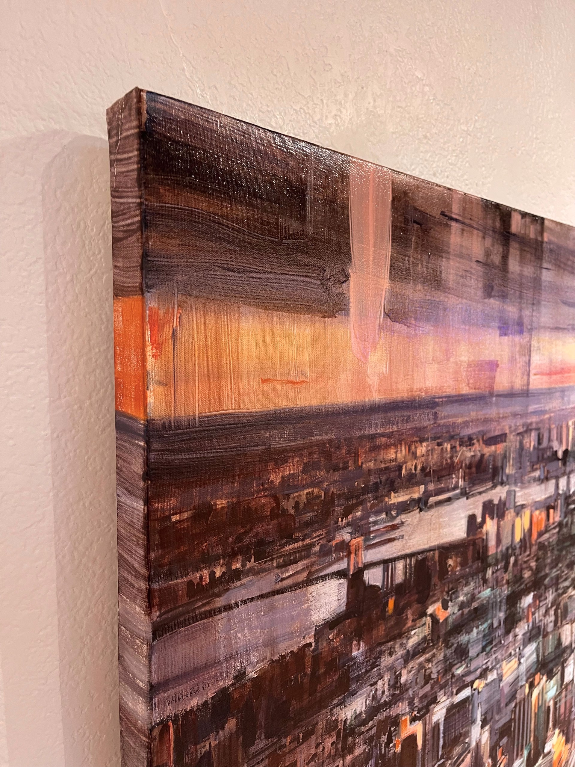A painting of a cityscape with a sunset in the background.