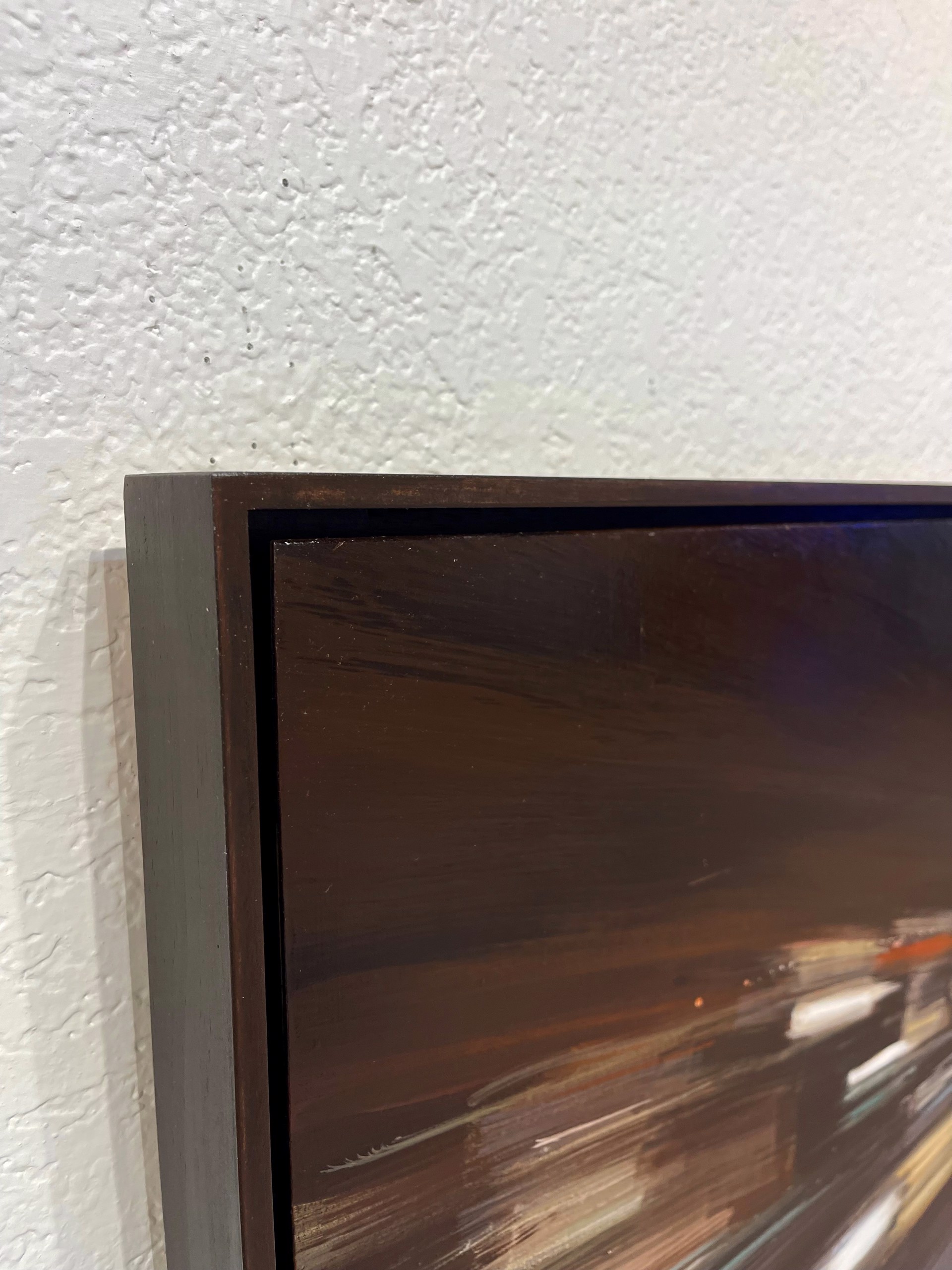 A painting of a city street at night with cars driving down it.